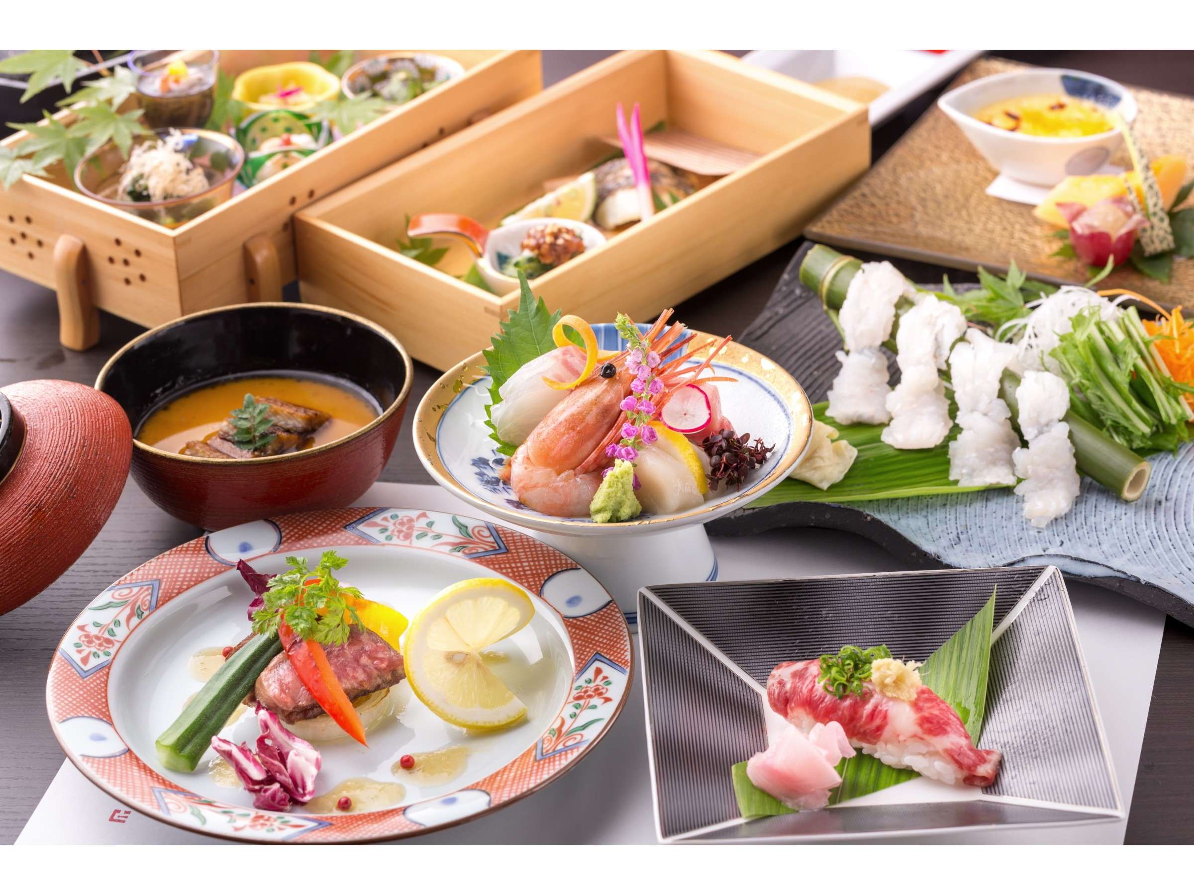 Kaiseki dinner spread at Satonoyu Waraku with seasonal Aso dishes, sashimi, wagyu and a tiered wooden box
