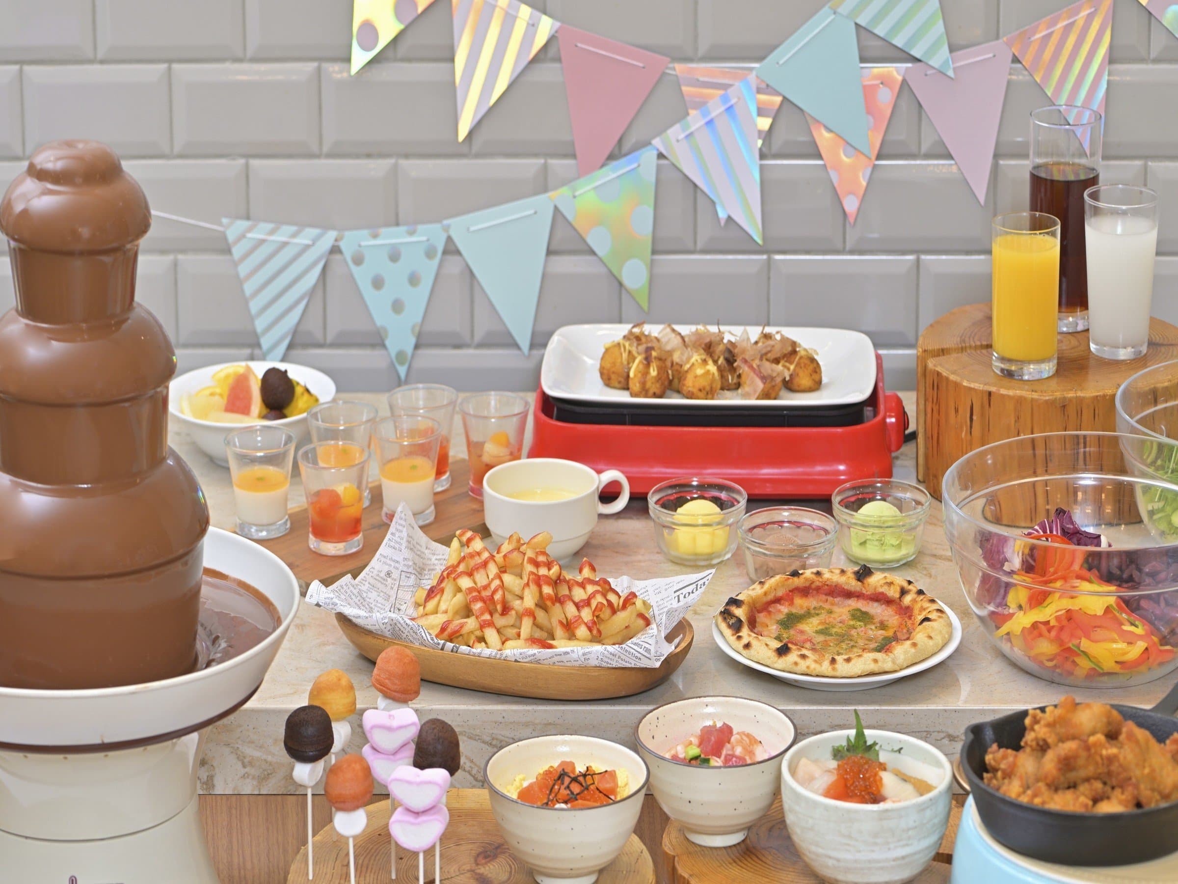 Dessert buffet spread with a chocolate fountain, sweets and fruit at Noboribetsu Manseikaku