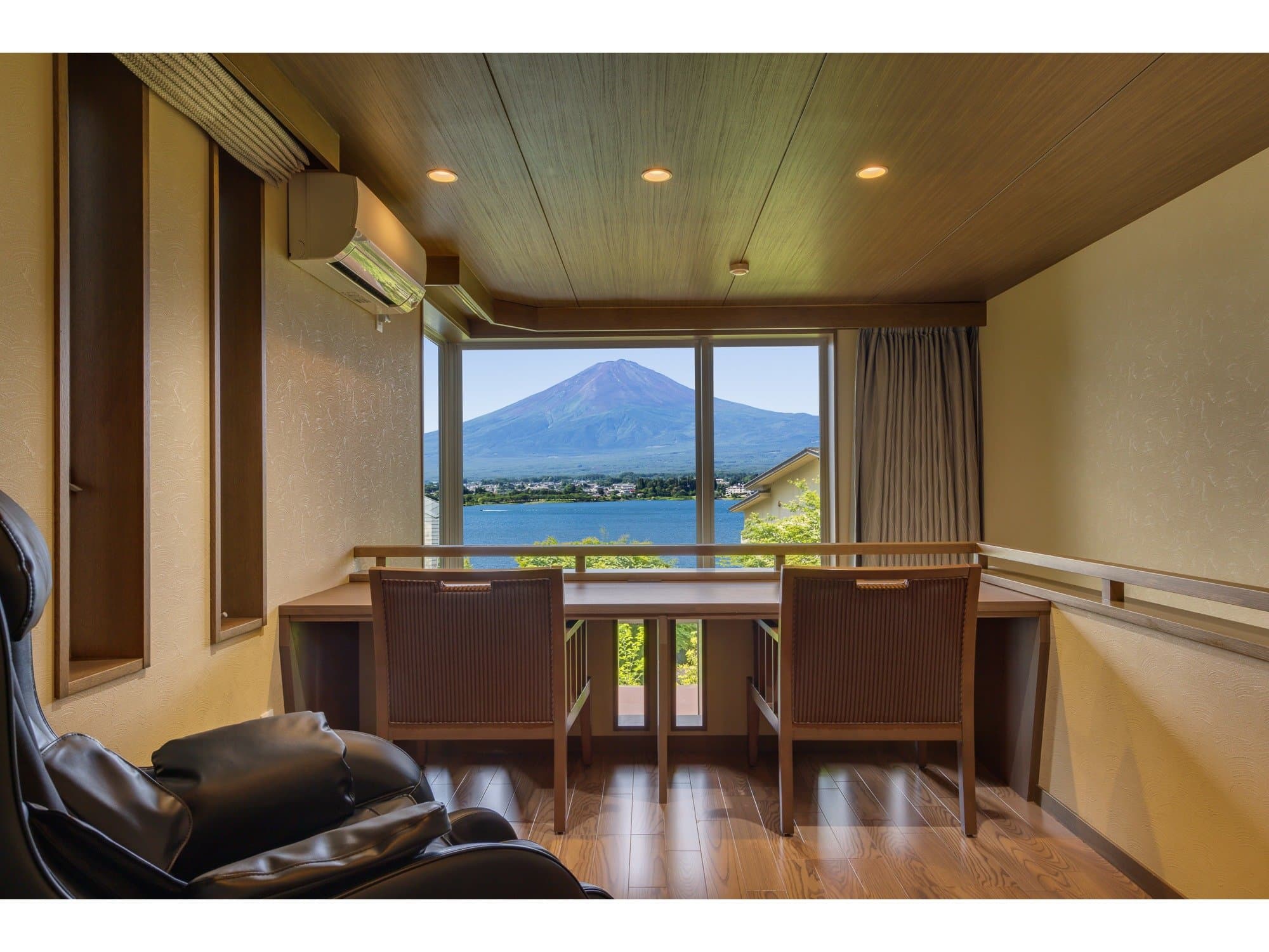 Lakeview guest room at Sunnide Resort with a corner window overlooking Mt Fuji rising above Lake Kawaguchiko