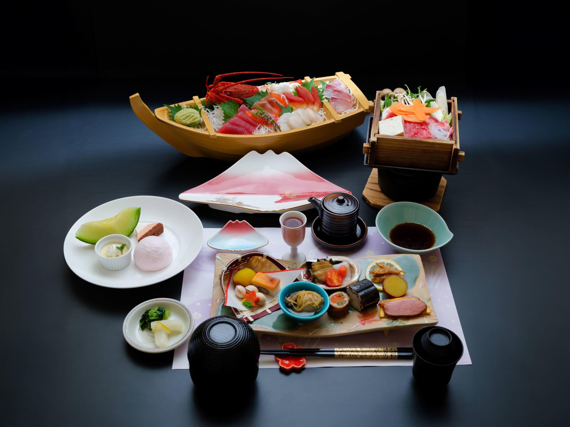 Kaiseki dinner at Sunnide Resort with a boat of sashimi, a hot pot and seasonal dishes on a Mt Fuji-shaped plate