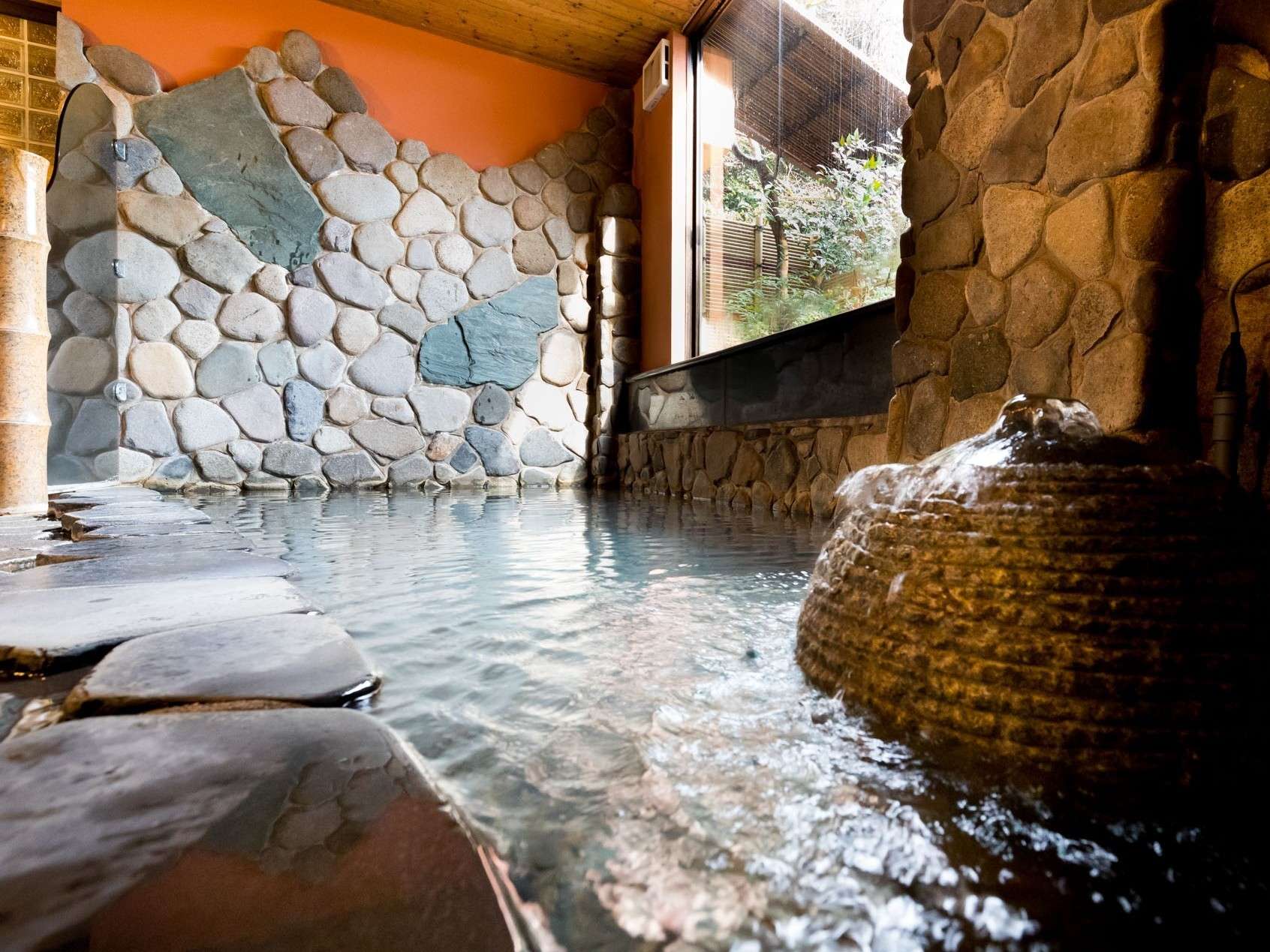 Yumekoyado Tenbouen Kinosaki Onsen indoor stone bath with masonry wall and natural light