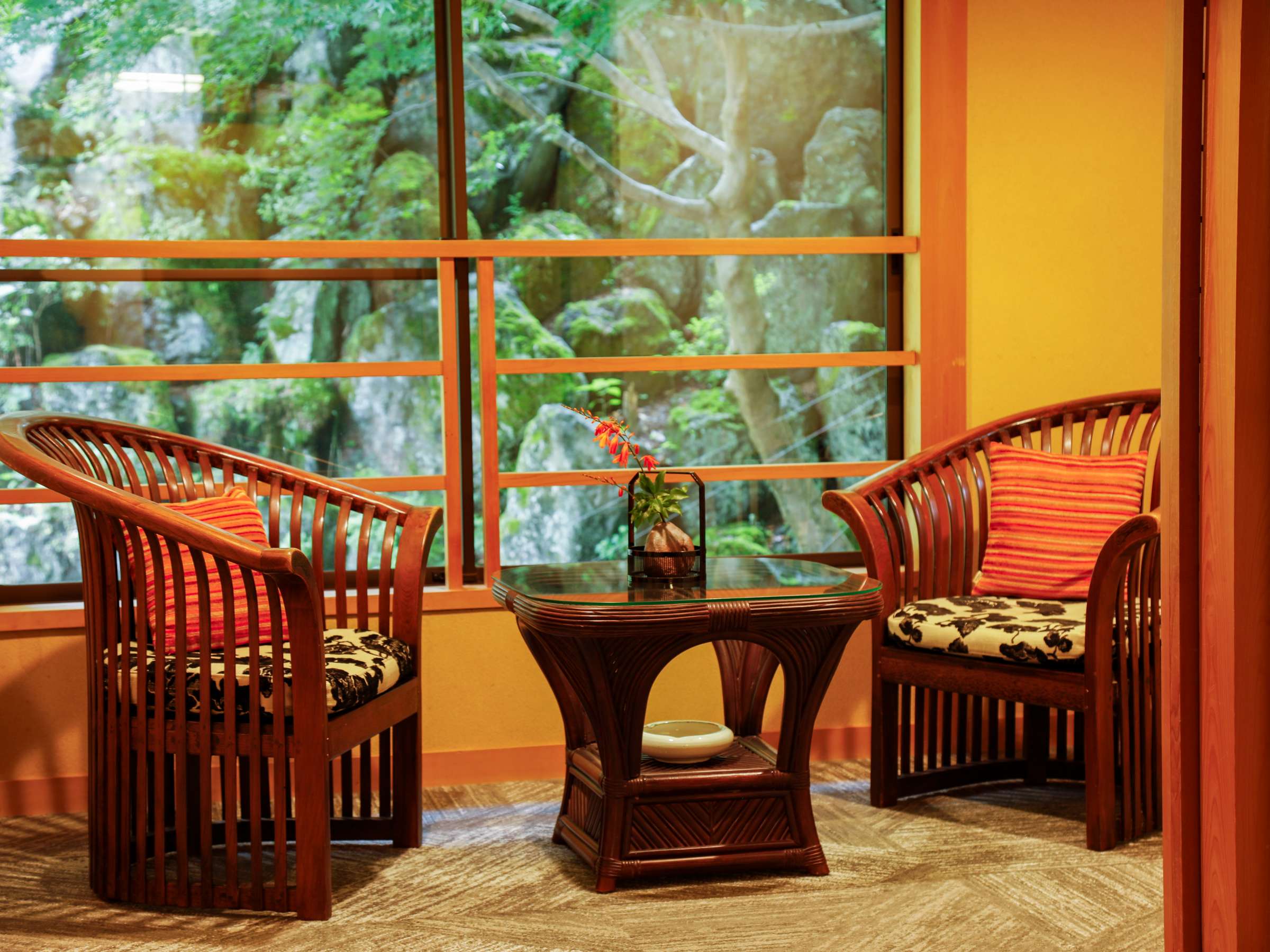 Yumekoyado Tenbouen Kinosaki Onsen rattan seating nook beside a window onto the garden