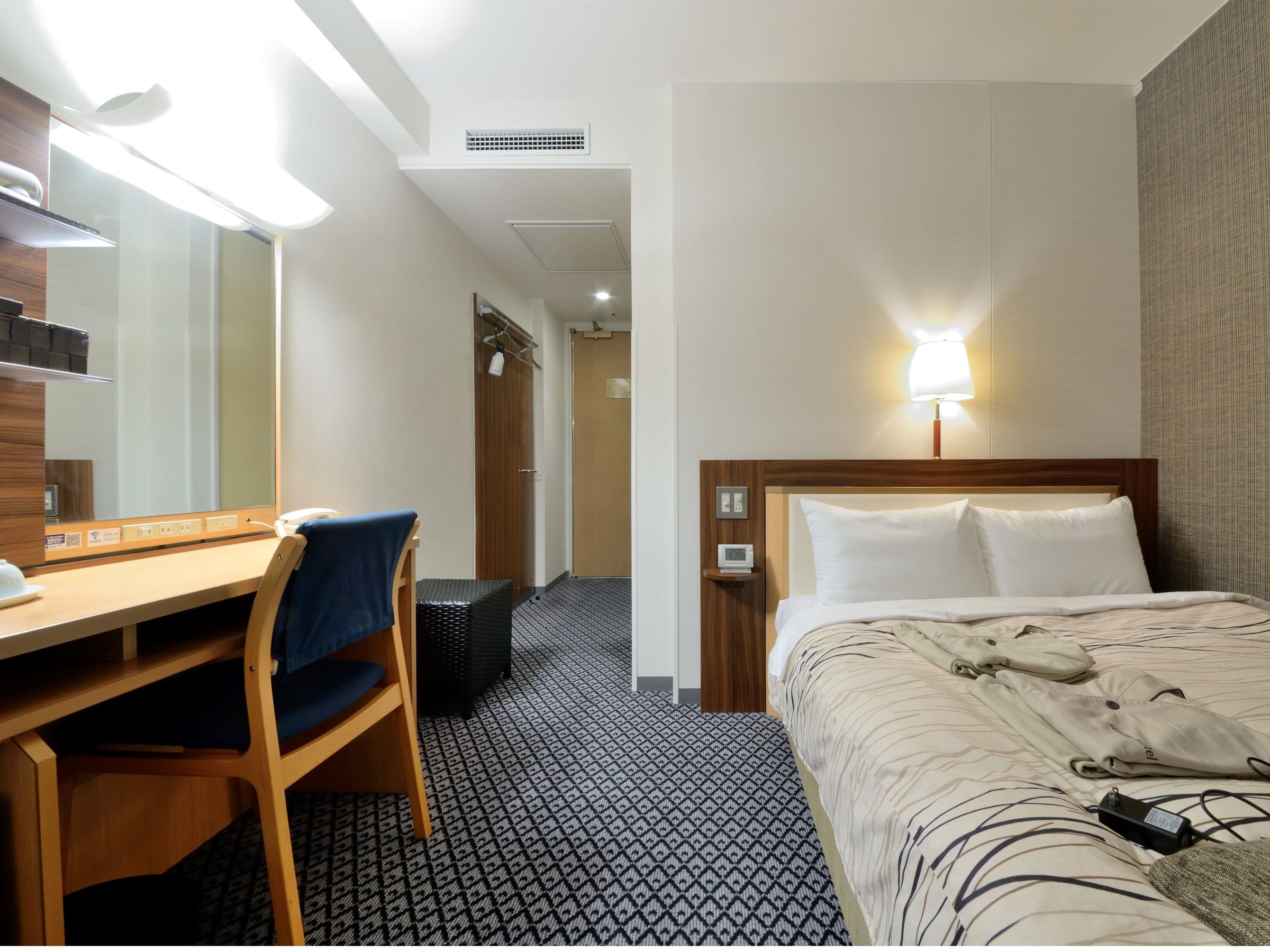 Double guest room with wide bed and work desk at Kanazawa Manten Hotel Ekimae