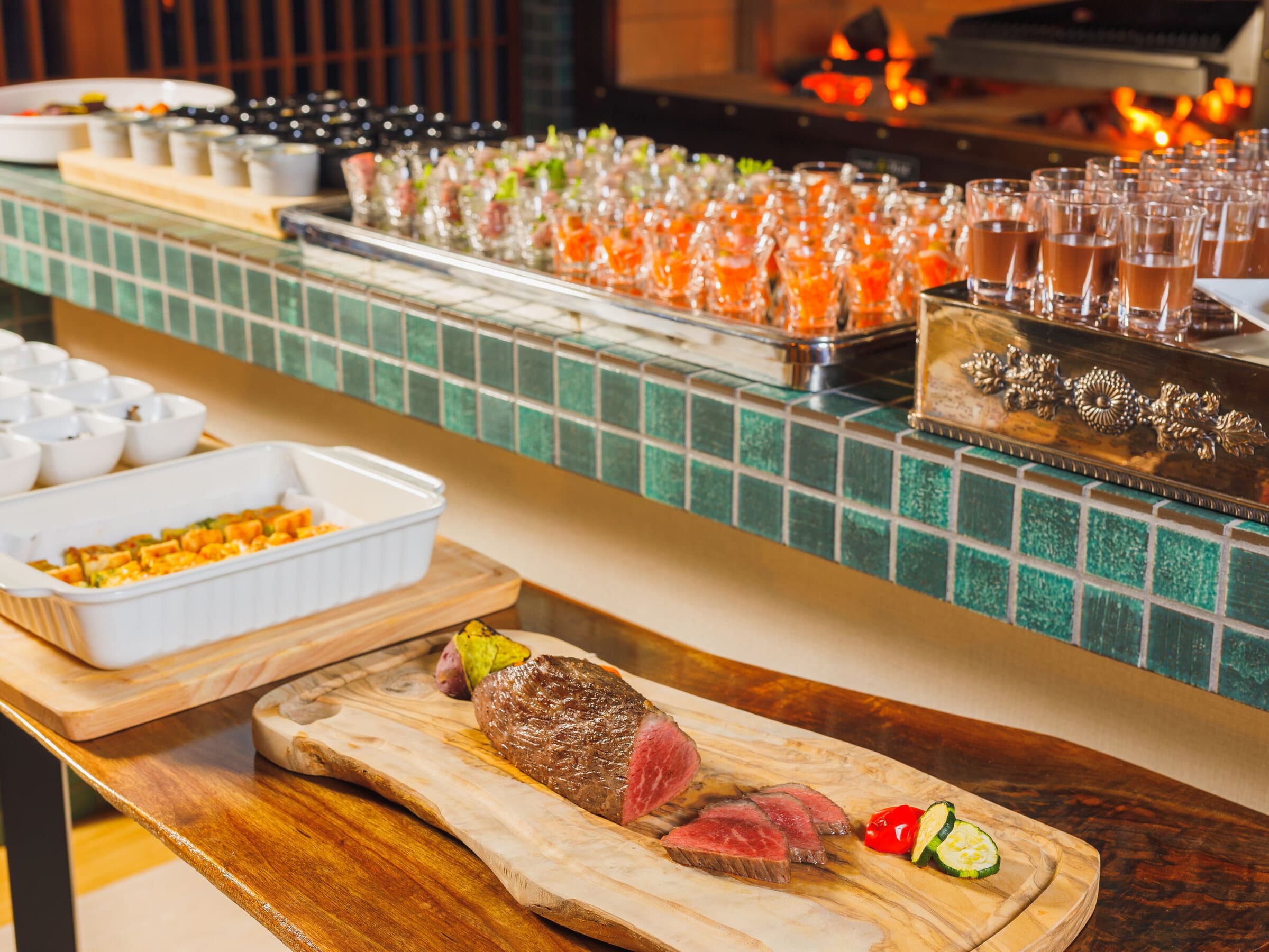 Buffet spread at Hotel Jurin with carved grilled beef on a wooden board and rows of appetizers