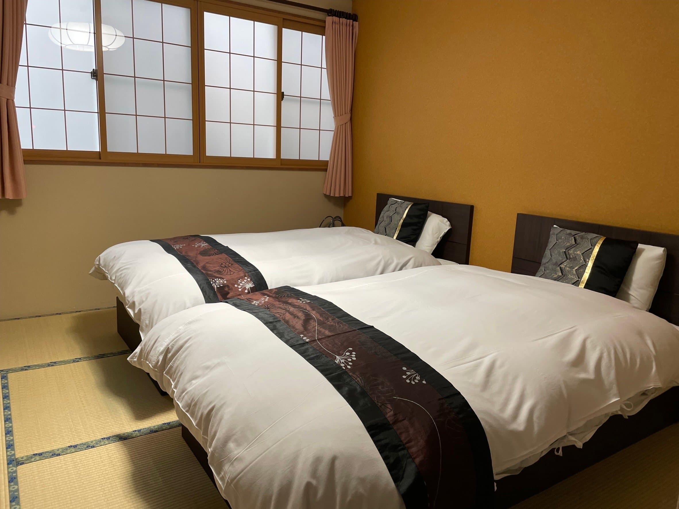 Bright twin-bed tatami room with mustard wall and large frosted shoji window