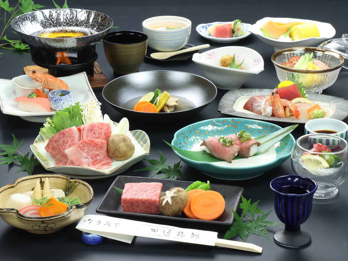 Full kaiseki dinner spread featuring Hida beef, sashimi and simmered dishes at Ryokan Tanabe