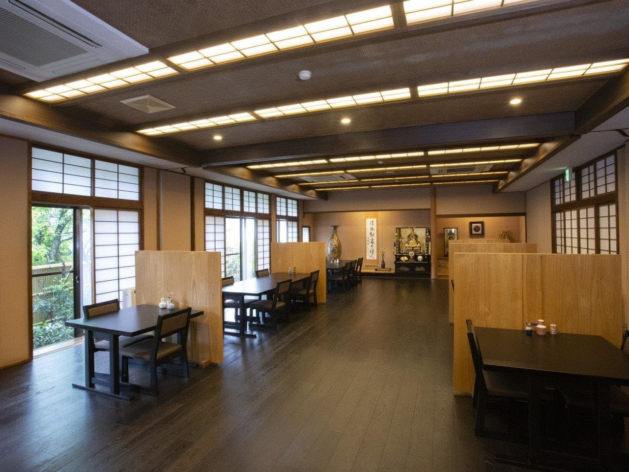 Modern dining hall with private wood-paneled booths at Wafu Ryokan Misato