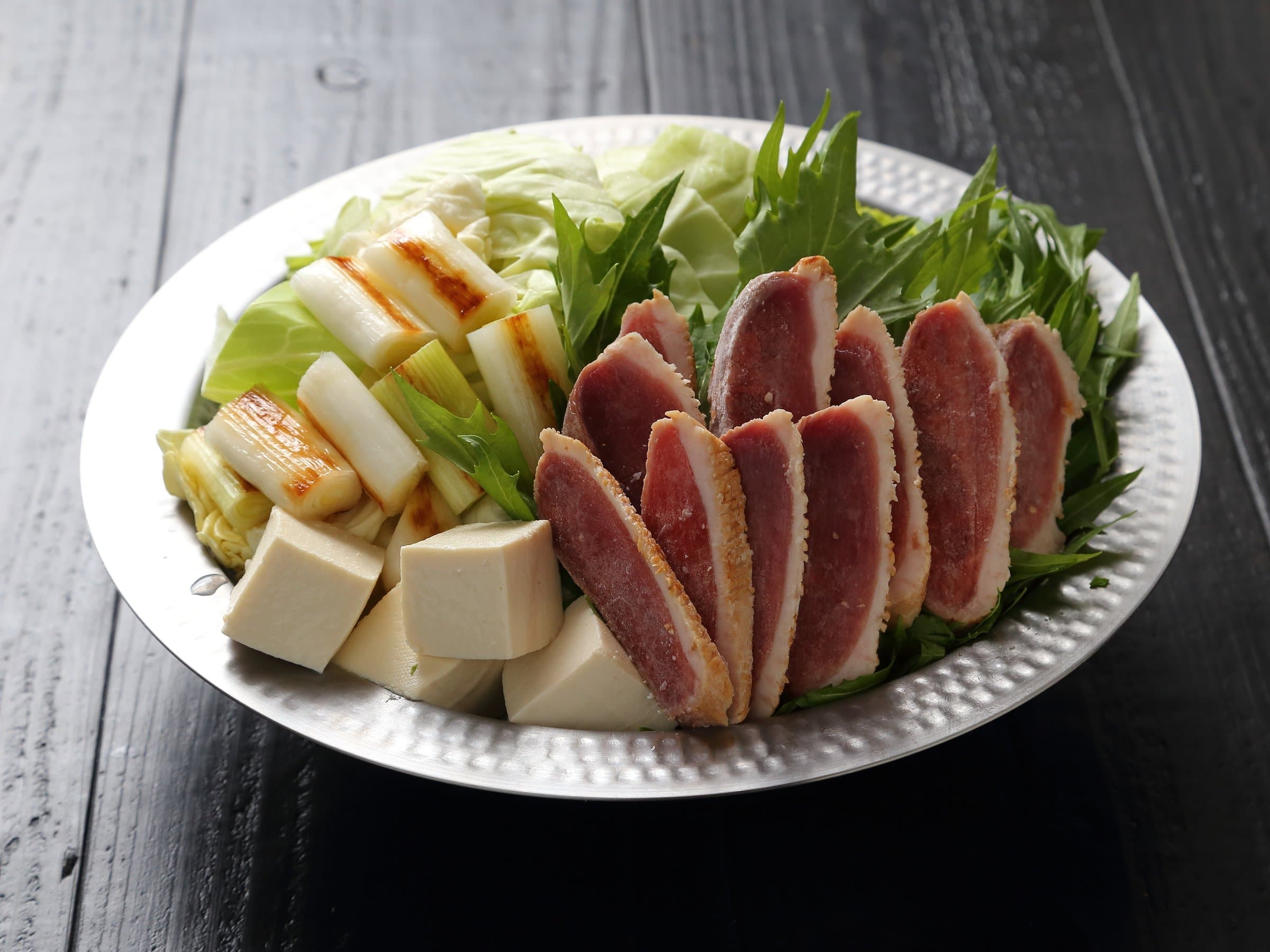 Hotpot platter of seared duck, tofu, leek and greens prepared for dinner at Hem's Hotel, Miyajima