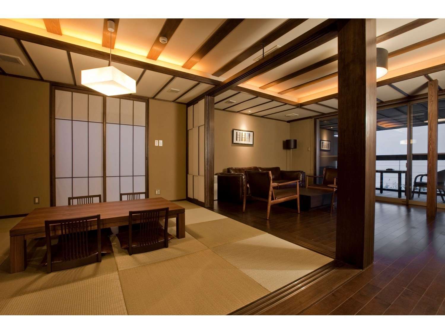 Tatami guest room with shoji screens, low wooden table and leather lounge seating beside a terrace, Amane Resort GAHAMA, Beppu Onsen