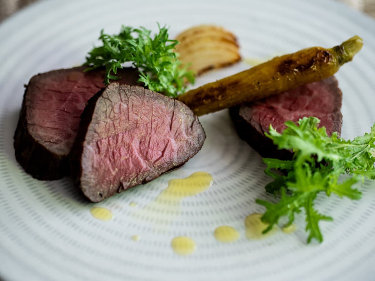 Plated roast beef main course with greens and grilled vegetable at Sanso Warabino's kaiseki dinner
