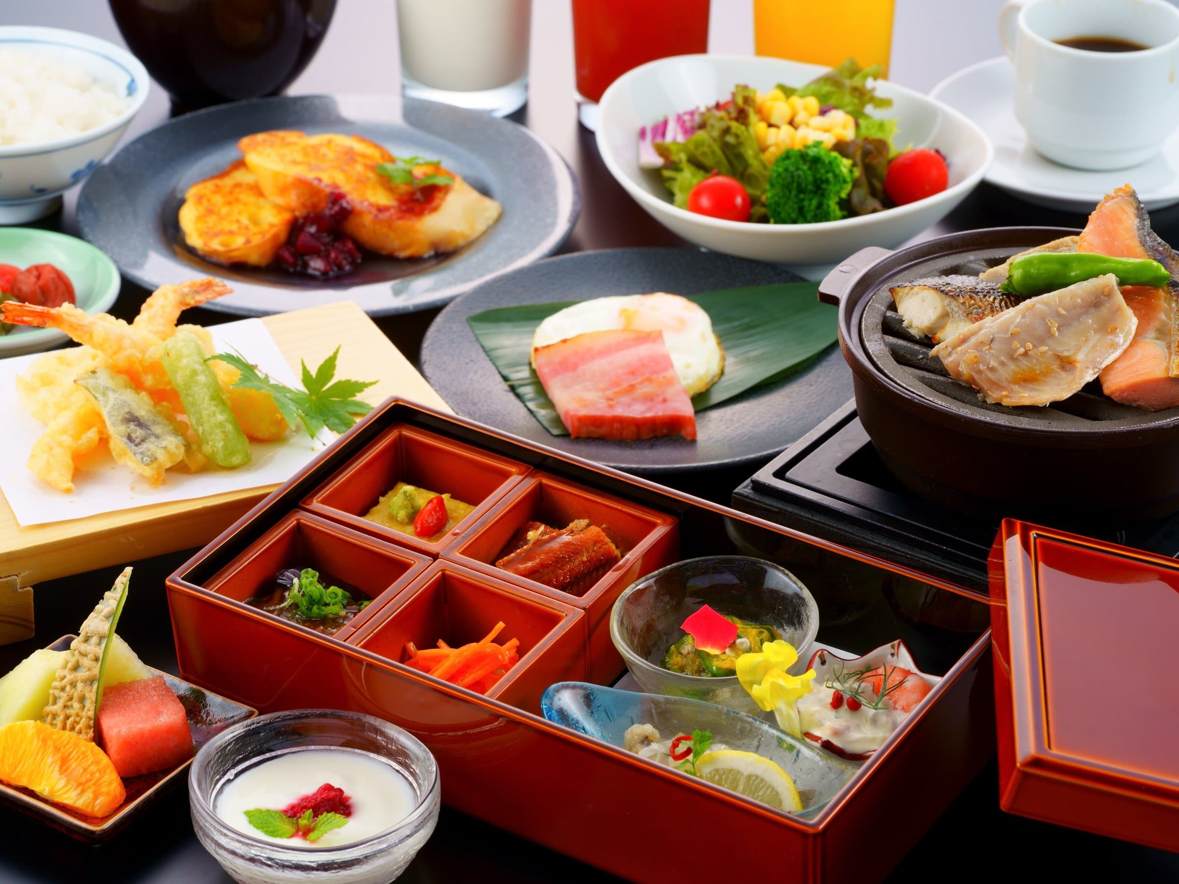 Japanese breakfast set in a lacquered tiered box with tempura, grilled fish, salad and side dishes