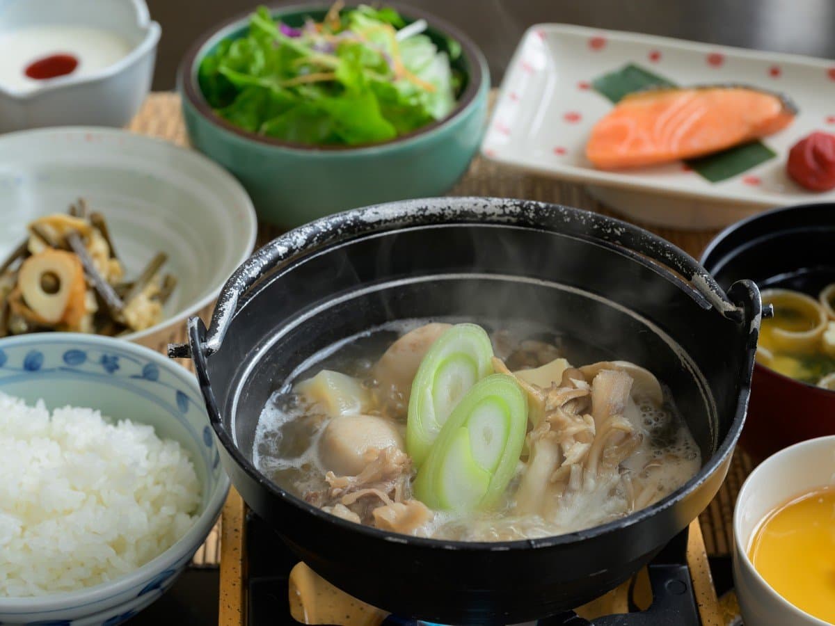Japanese breakfast set with grilled salmon, hot pot, rice, miso soup and side dishes at Zao Onsen