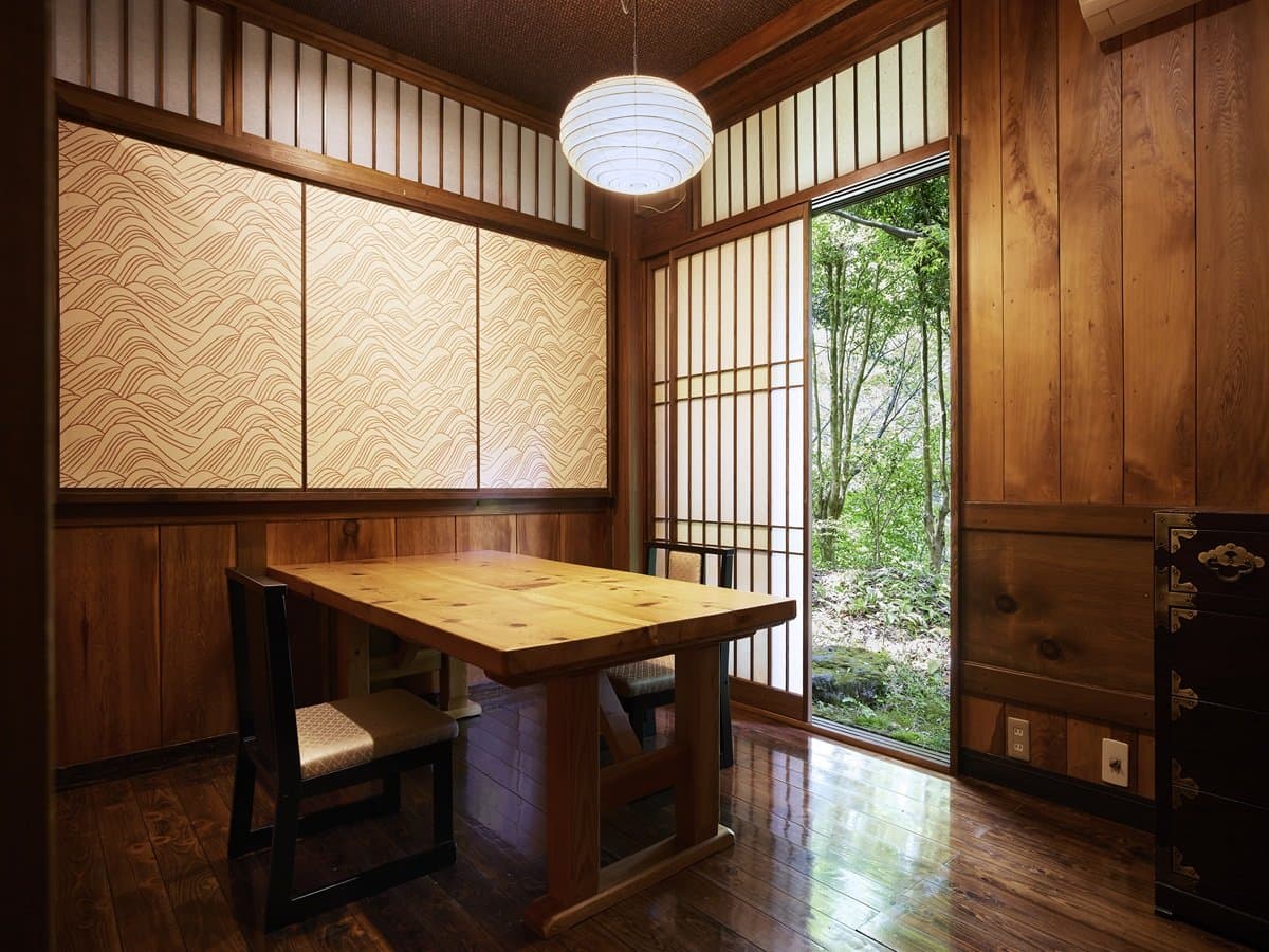 Private dining room with a sunken table, hanging lantern and garden view