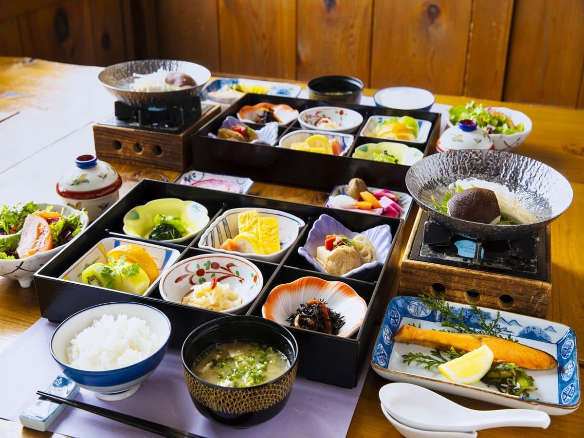 Japanese breakfast set with rice, grilled fish and assorted small dishes