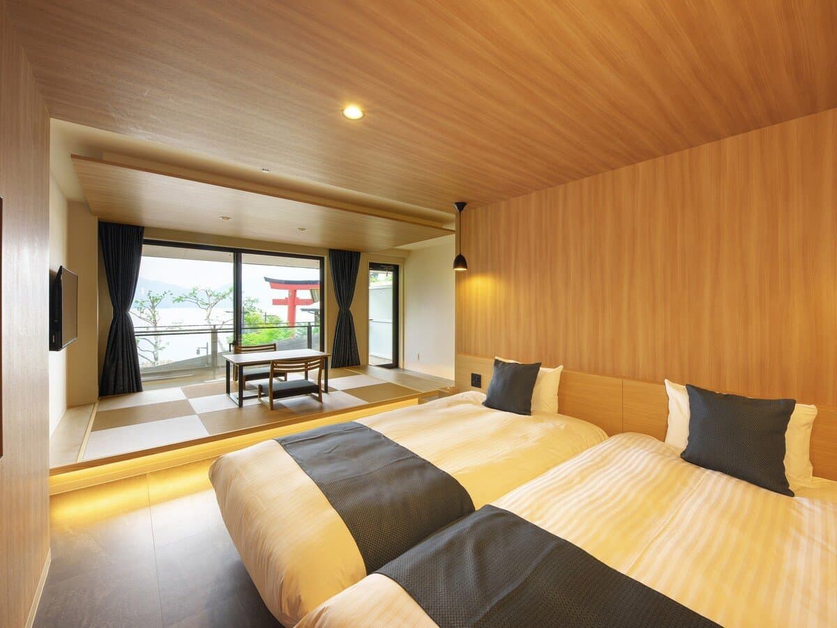 Guest room at Hotel Hana-An with twin beds, a raised tatami area, and a Lake Chuzenji torii view
