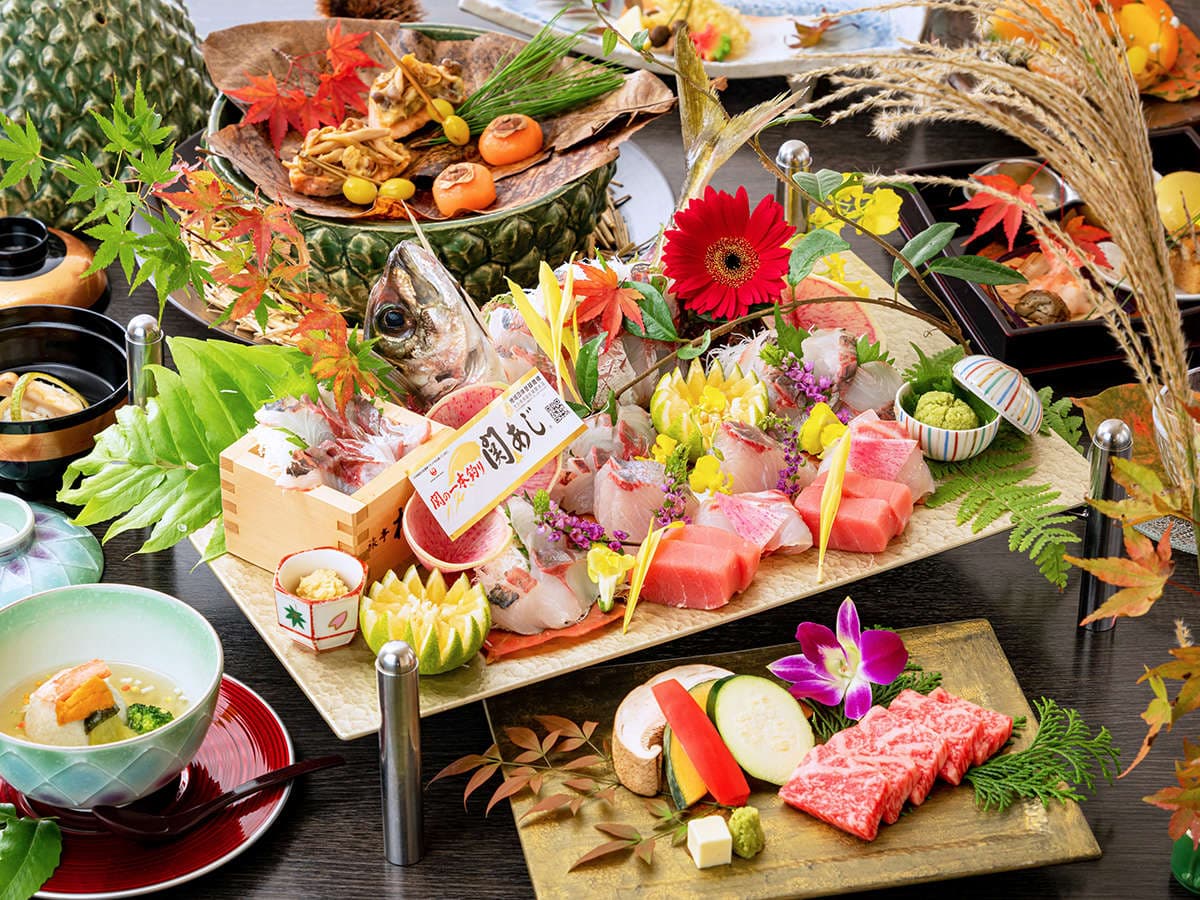 Elaborate kaiseki dinner spread with sashimi, wagyu beef and seasonal dishes on tiered presentation stands, Ryotei Matsubaya, Beppu Onsen