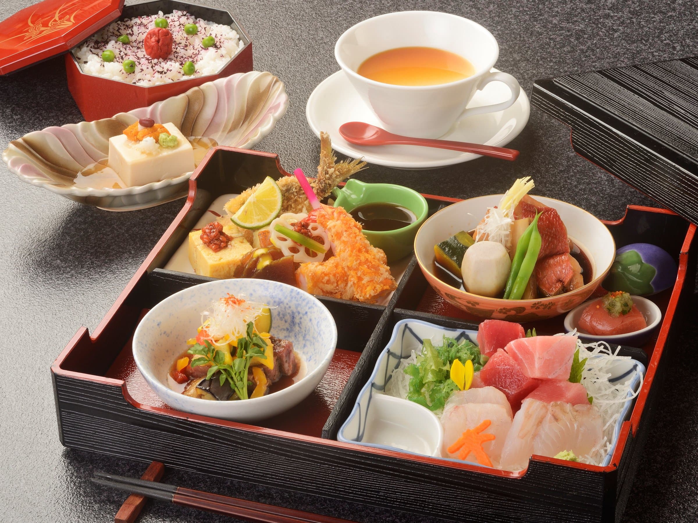 Japanese set meal in a lacquered box with sashimi, soup and side dishes at Inatori Ginsuiso