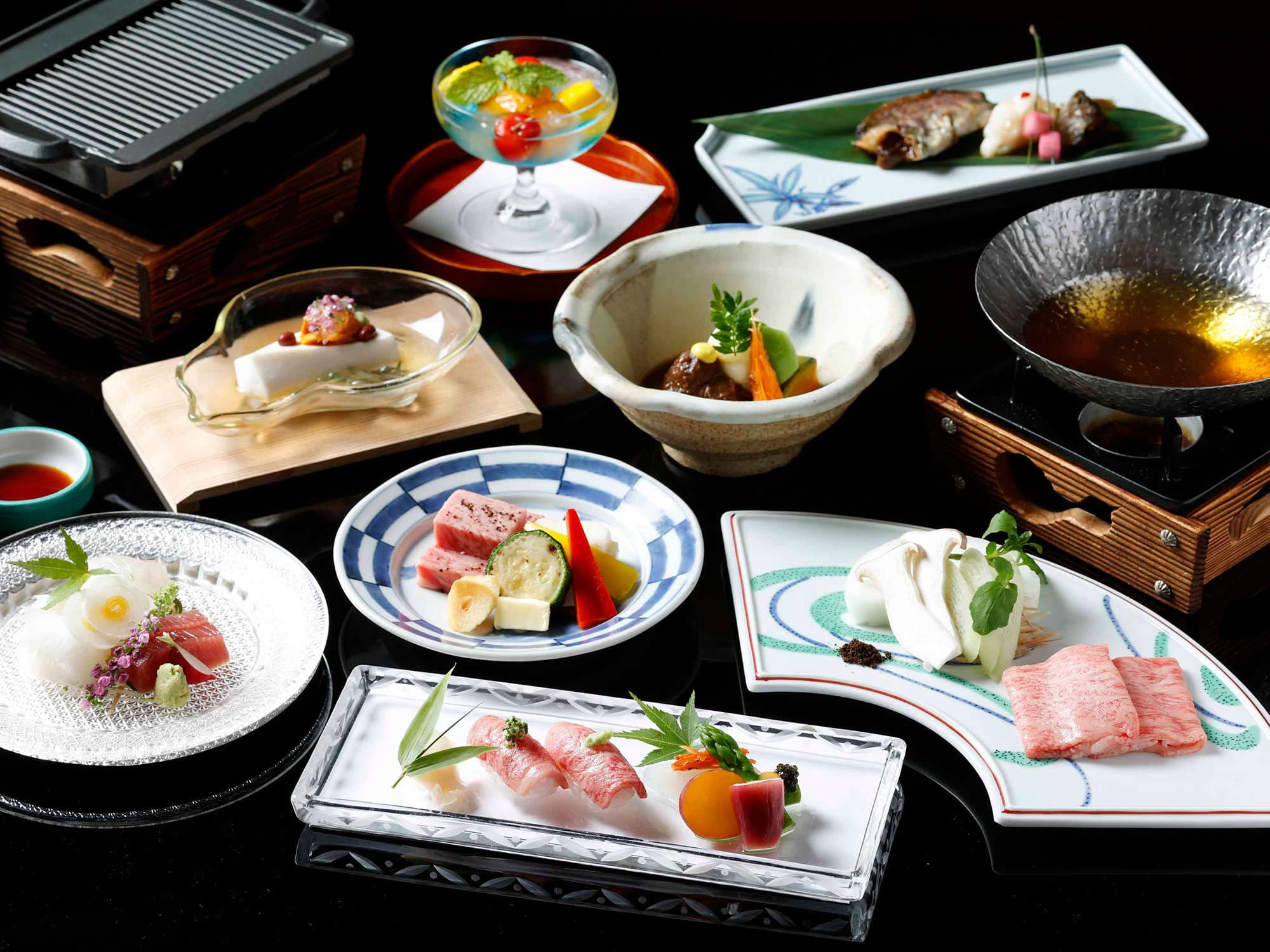 Multi-course Hida beef kaiseki spread of seasonal small dishes on lacquer and ceramic ware, Suimeikan, Gero Onsen