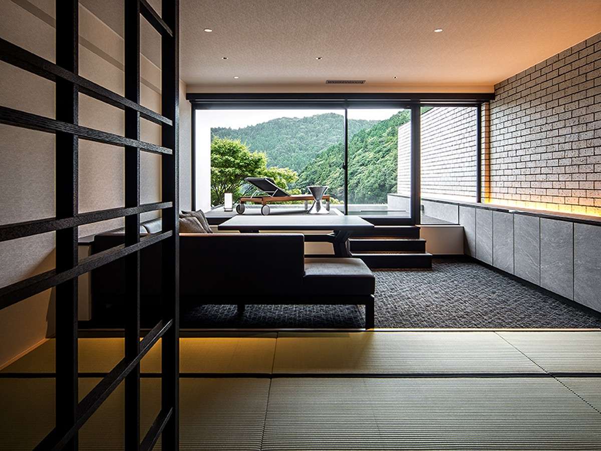 Modern tatami guest room at Unzen Azumaen with low sofa, private terrace and forested mountain view