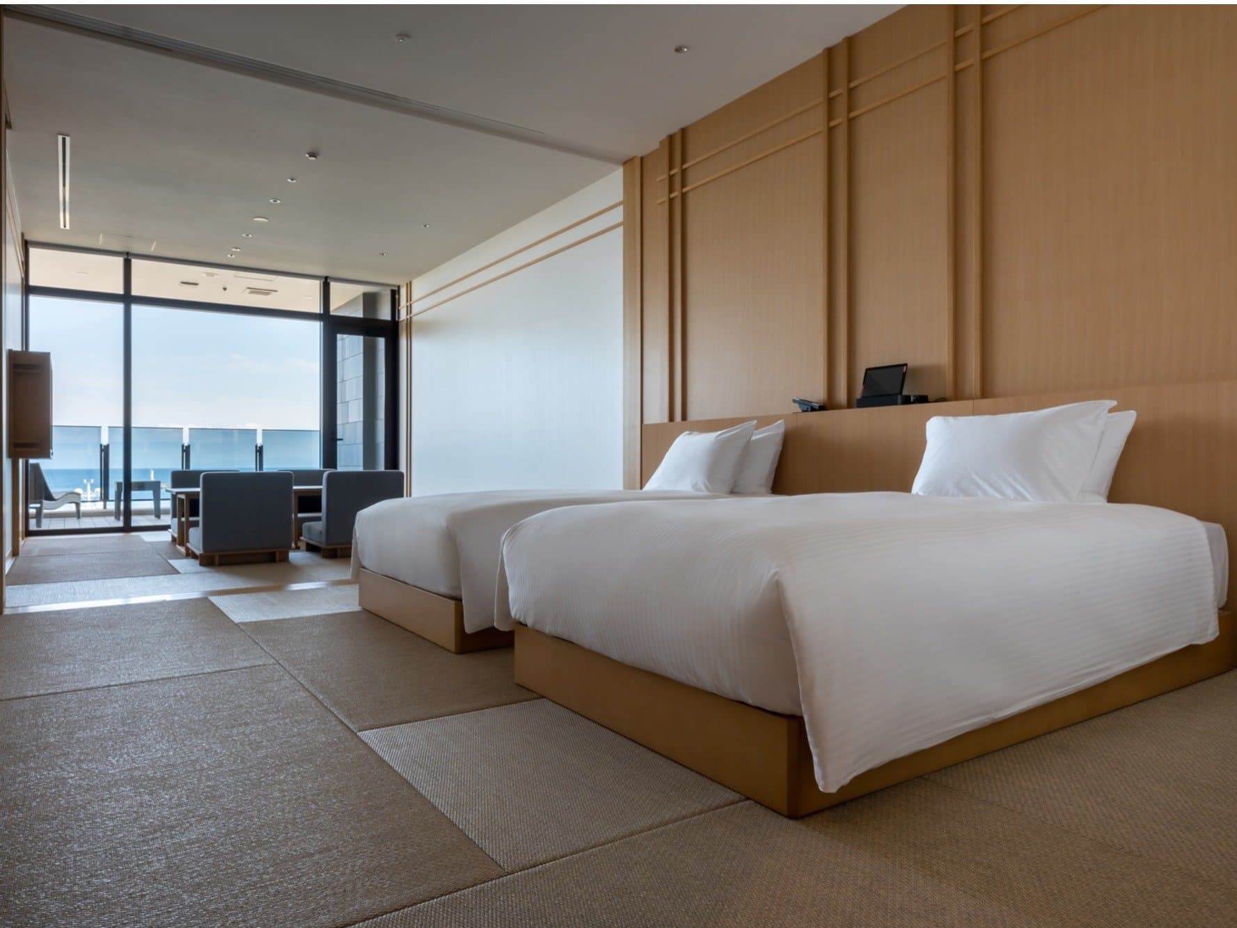 Twin guest room with tatami flooring and floor-to-ceiling ocean view at Pearl Star Hotel Atami