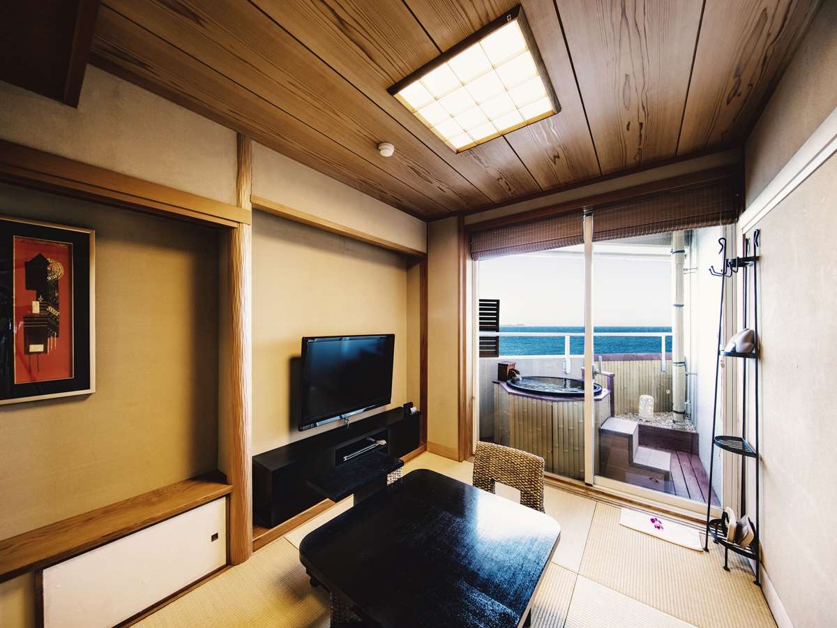 Tatami guest room with low table and a private oceanview balcony rotenburo bath in Izu