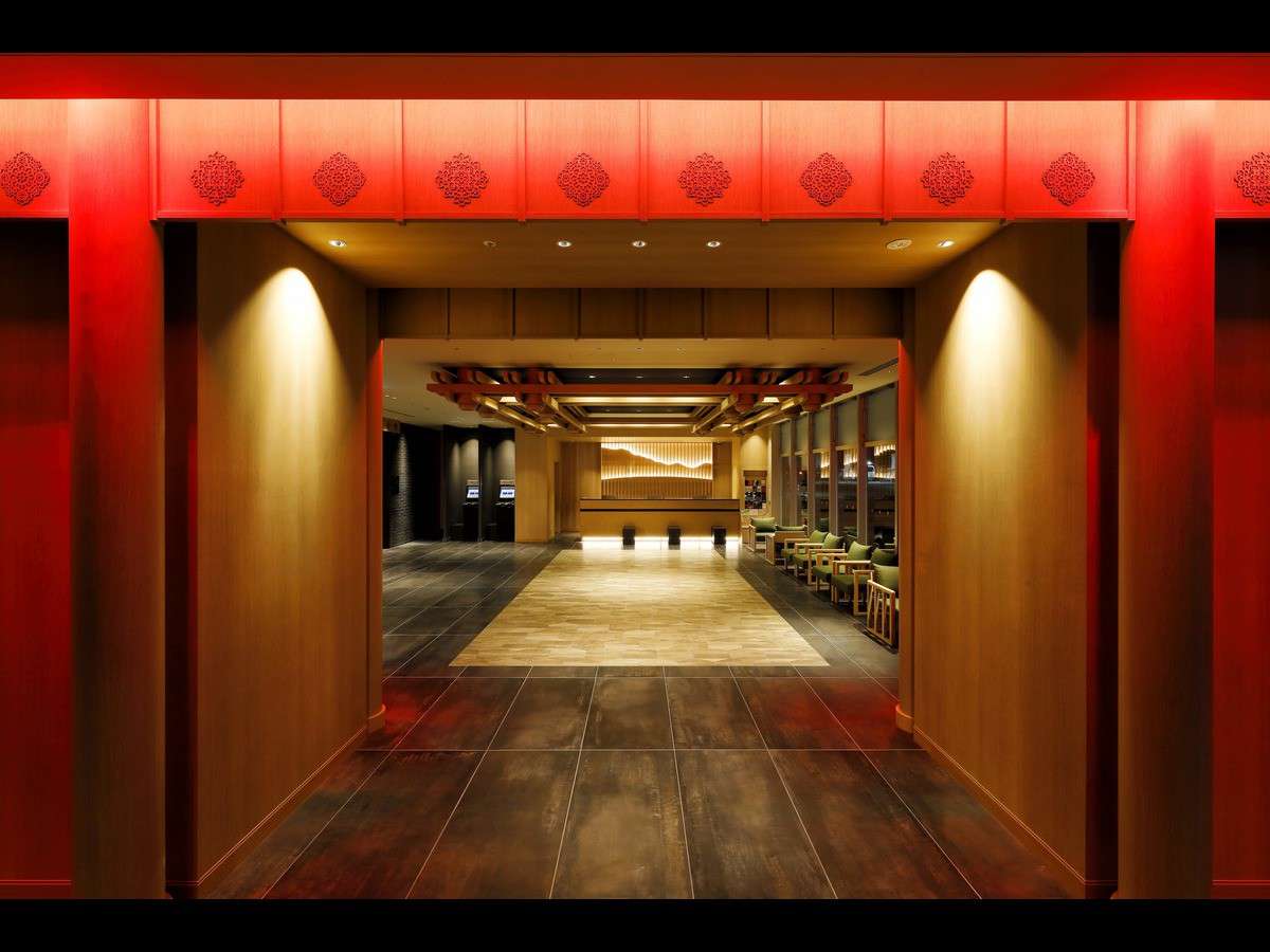Lobby entrance framed by a red lacquered gateway leading to the wood-toned reception at Daiwa Roynet Hotel Nara