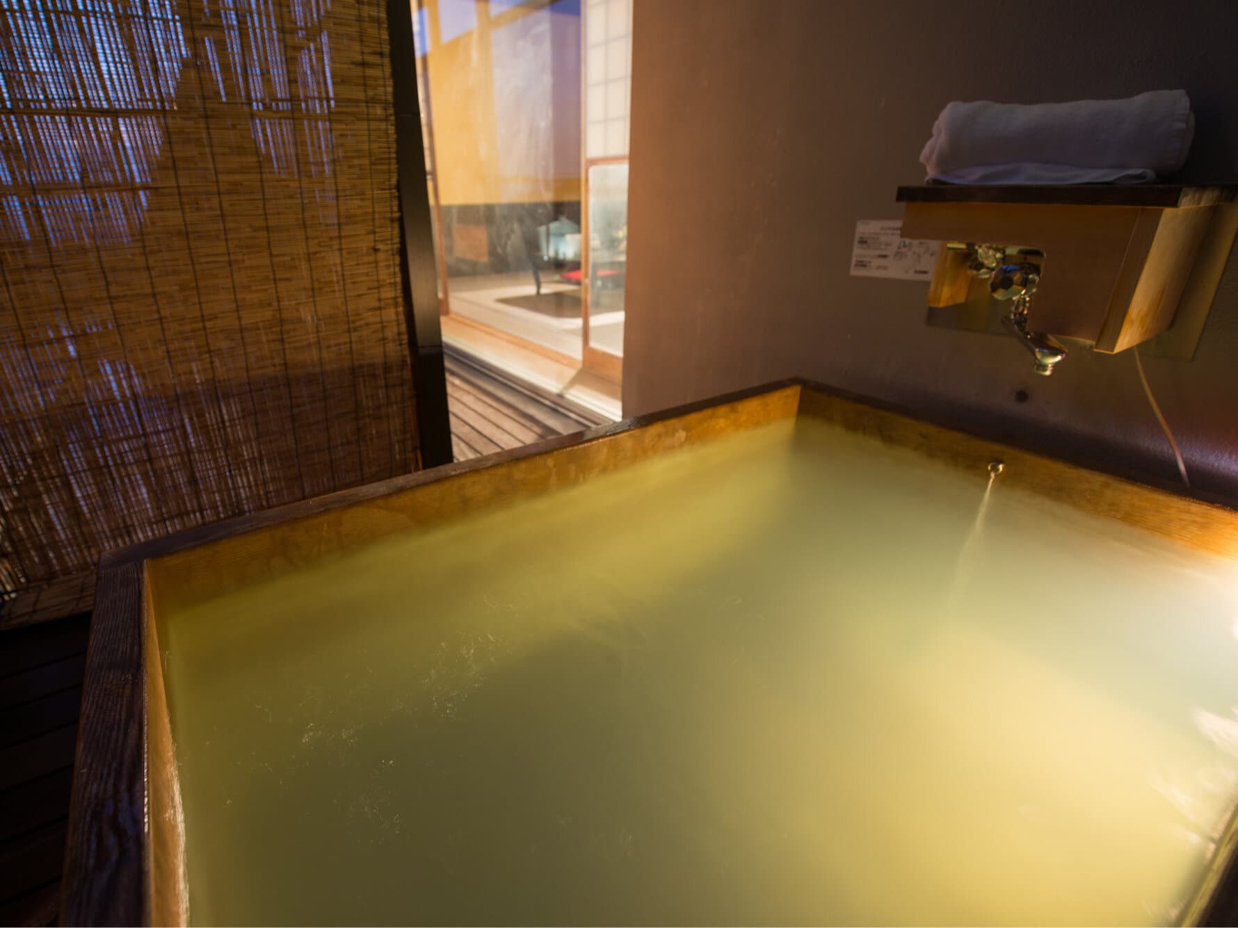 Private in-room cypress bath filled with cloudy golden Zao Onsen hot spring water