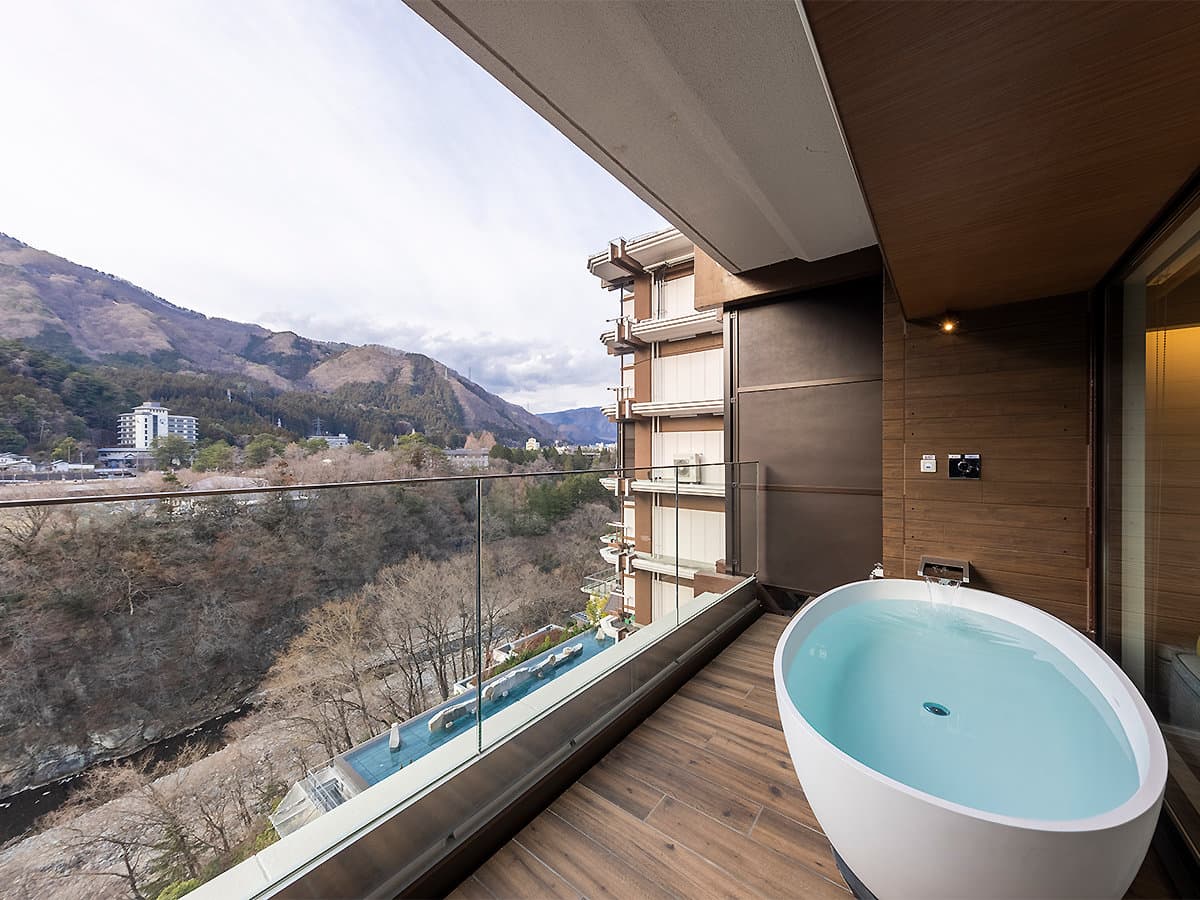 Private in-room terrace soaking bath overlooking the Kinugawa River gorge and surrounding mountains