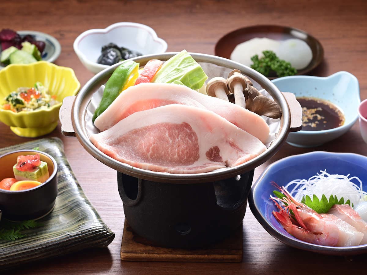 Multi-course kaiseki dinner at Ryokan Tamura with a tabletop pork hotpot, sashimi and assorted small dishes