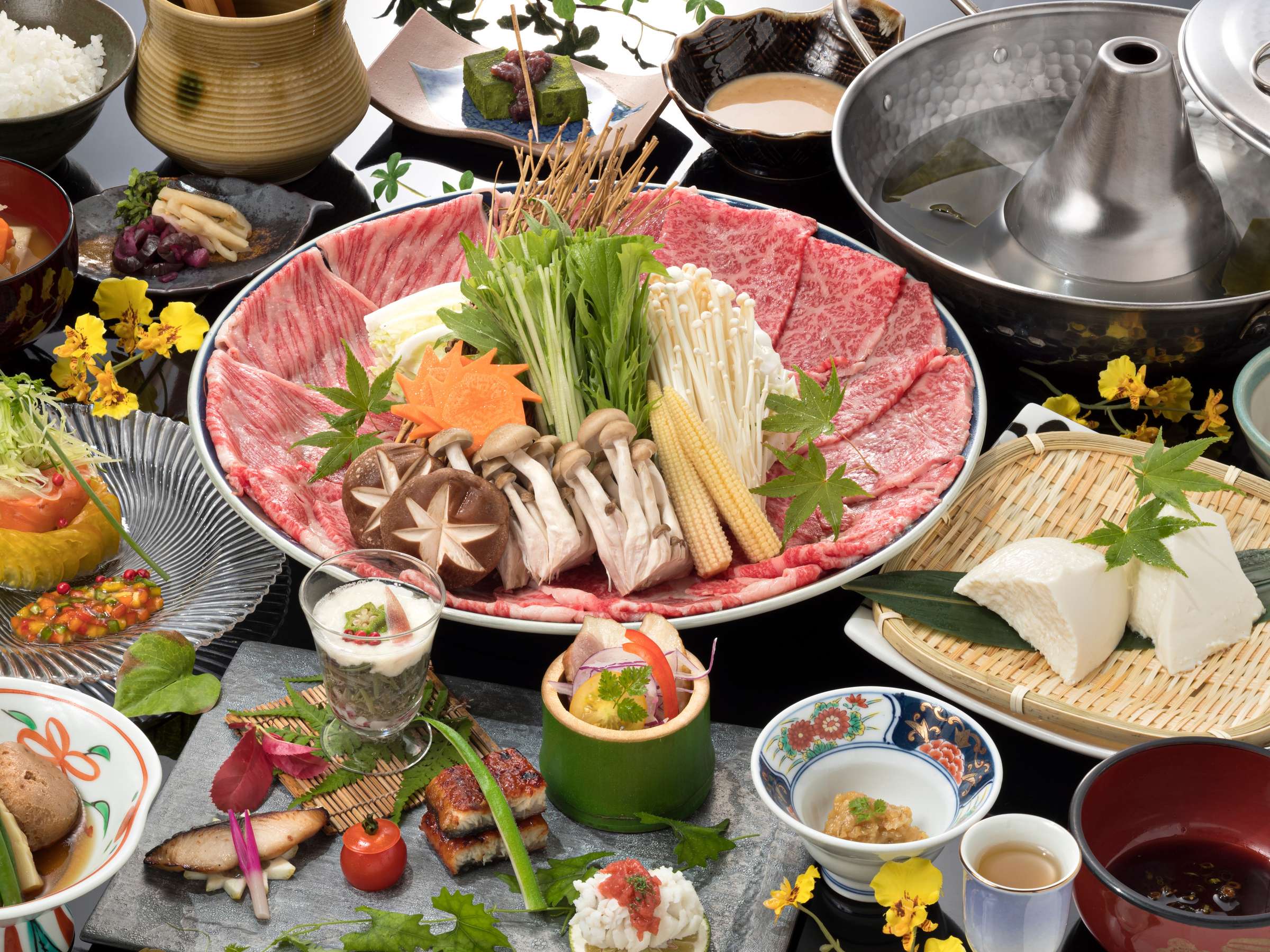 Lavish kaiseki dinner spread with wagyu sukiyaki hotpot, sashimi and seasonal small dishes at Onjuku Yagura