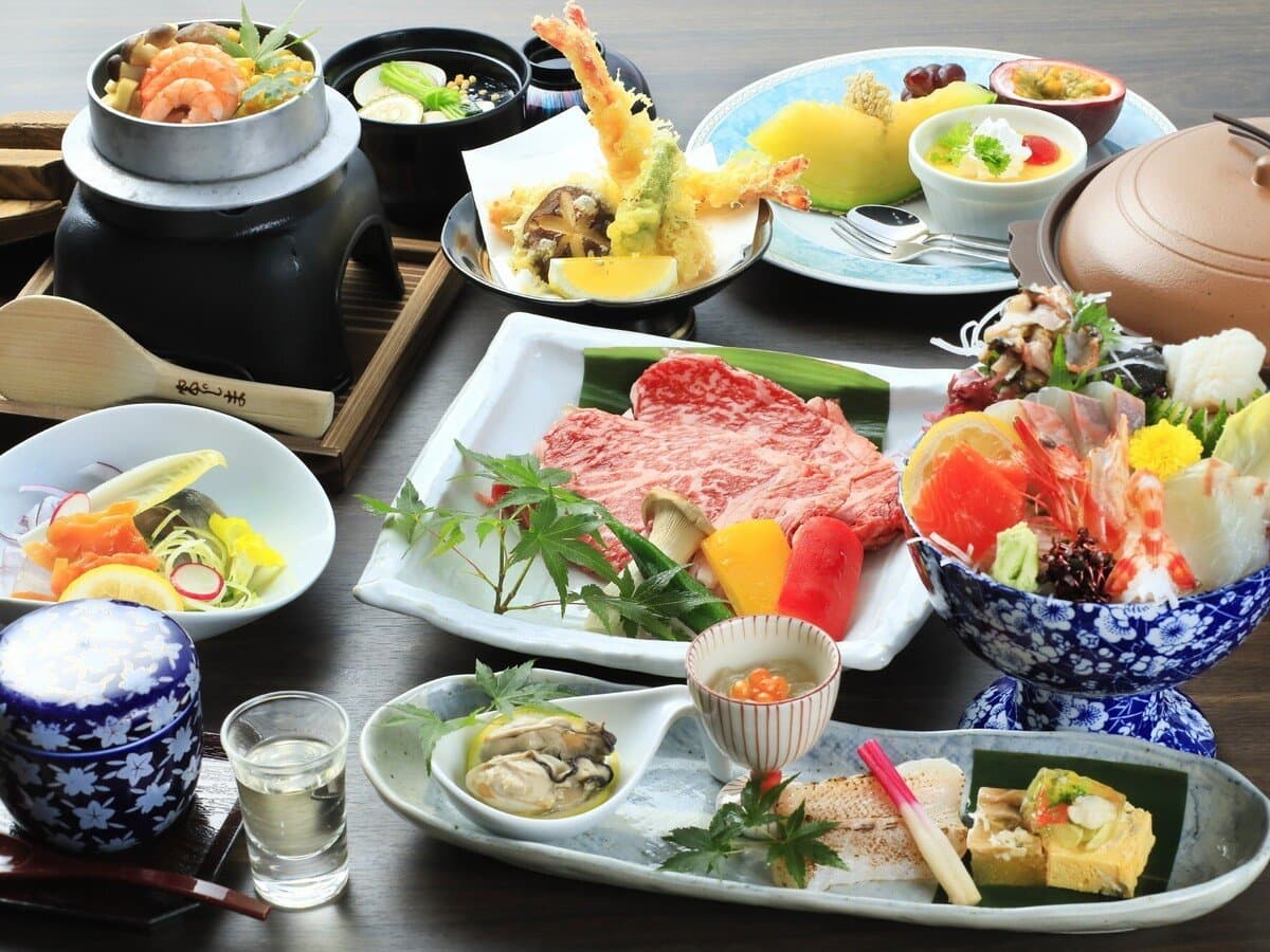Kaiseki dinner spread at Hotel Kikunoya featuring grilled wagyu beef, tempura, sashimi and local Miyajima oysters