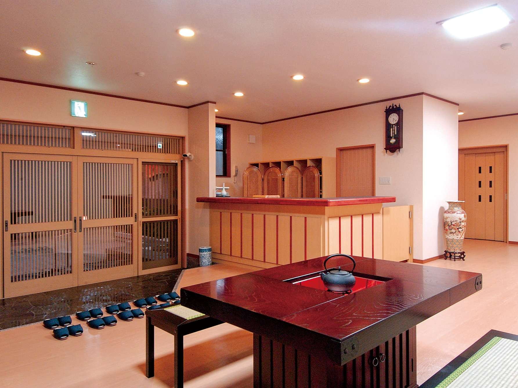 Lobby and reception hall with irori-style table at Ryokan Tsukimiso, Ibusuki