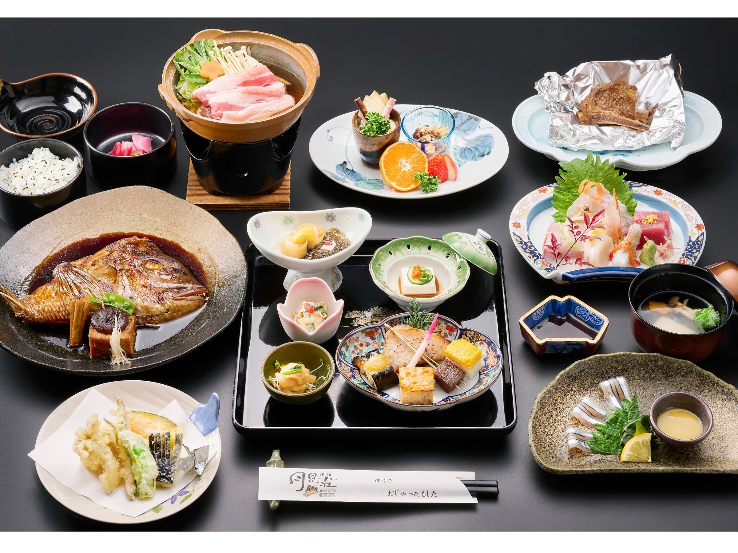 Multi-course kaiseki dinner spread with simmered sea bream and sashimi at Ryokan Tsukimiso, Ibusuki Onsen