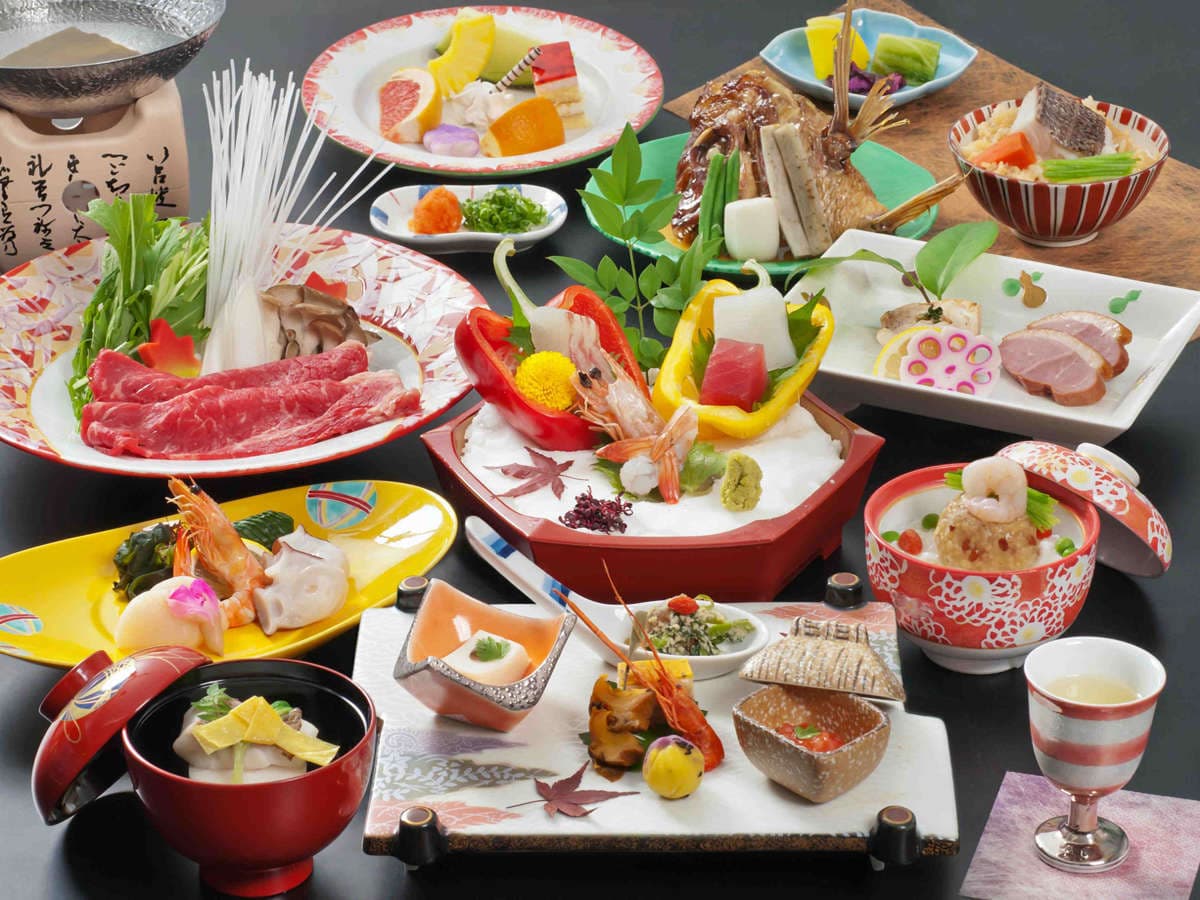 Multi-course kaiseki dinner at Dogo Prince Hotel with sashimi, simmered seafood and seasonal small dishes on lacquerware
