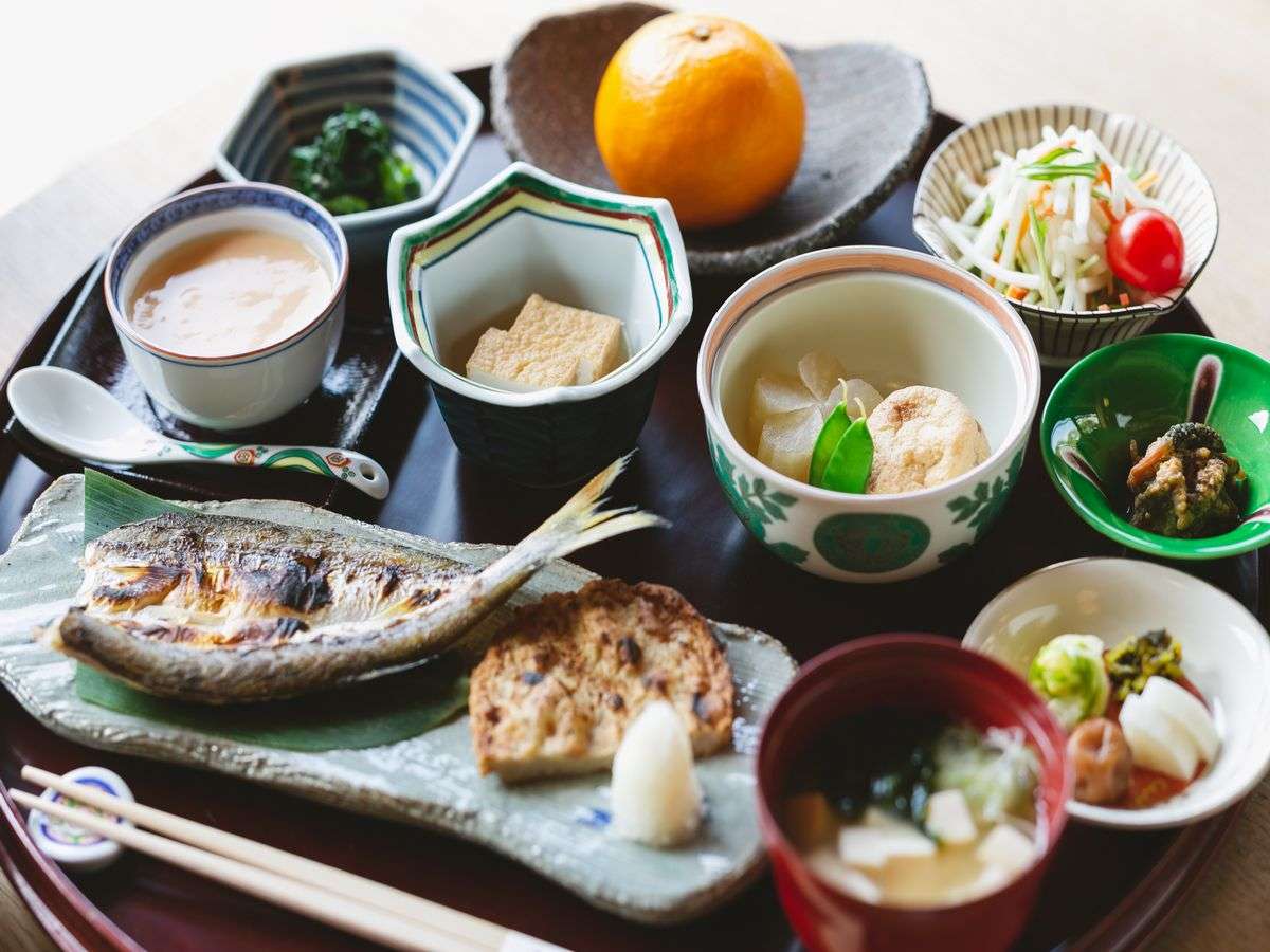 Japanese breakfast tray at Umenoya with grilled fish, simmered dishes, miso soup and a fresh Ehime citrus