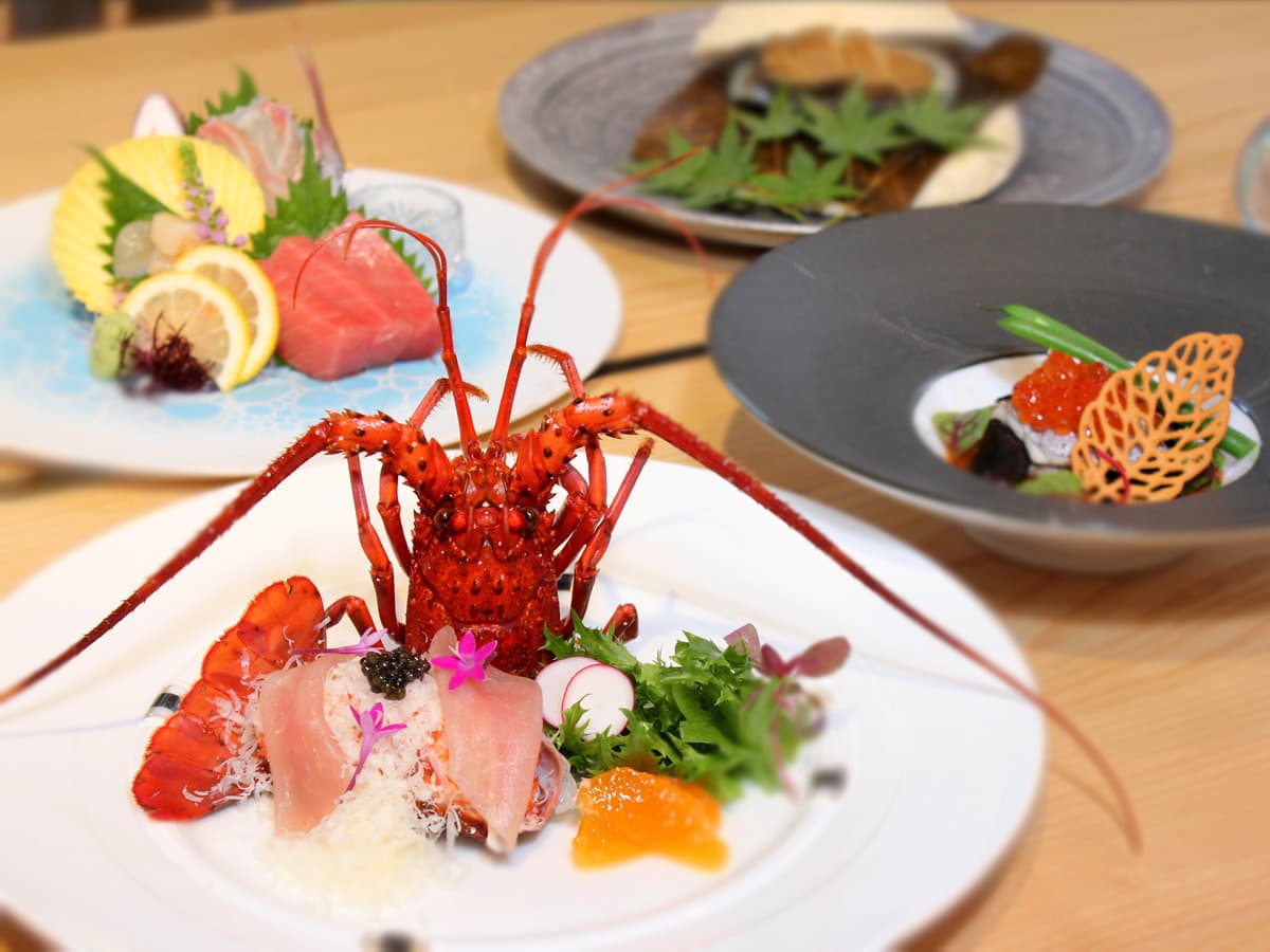 Multi-course kaiseki dinner spread with spiny lobster sashimi and seasonal dishes at Yamanote Bettei Hagakure