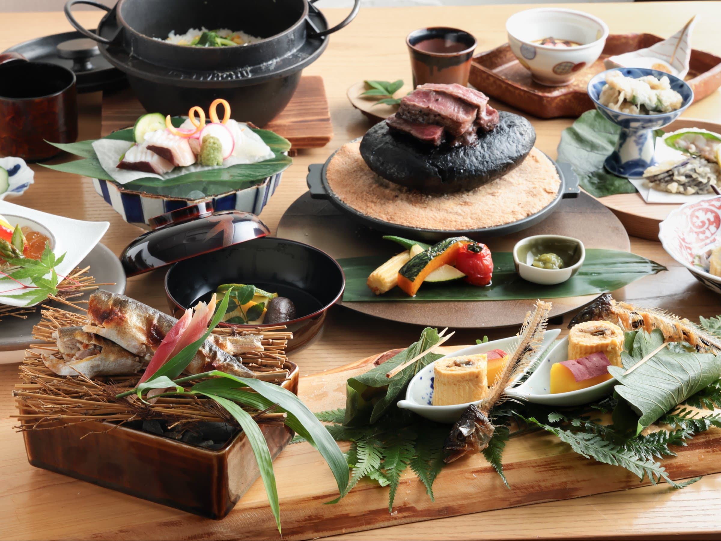 Kaiseki dinner spread at Bisei Yufuin with grilled fish, stone-grilled beef and seasonal small dishes