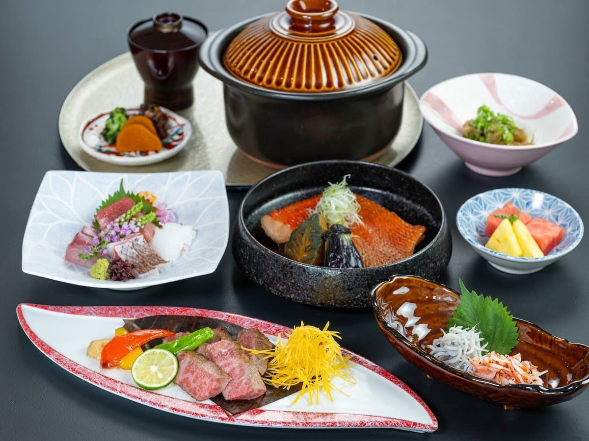 Kaiseki dinner spread with wagyu, sashimi and simmered fish in a clay pot at ISHINOYA Atami