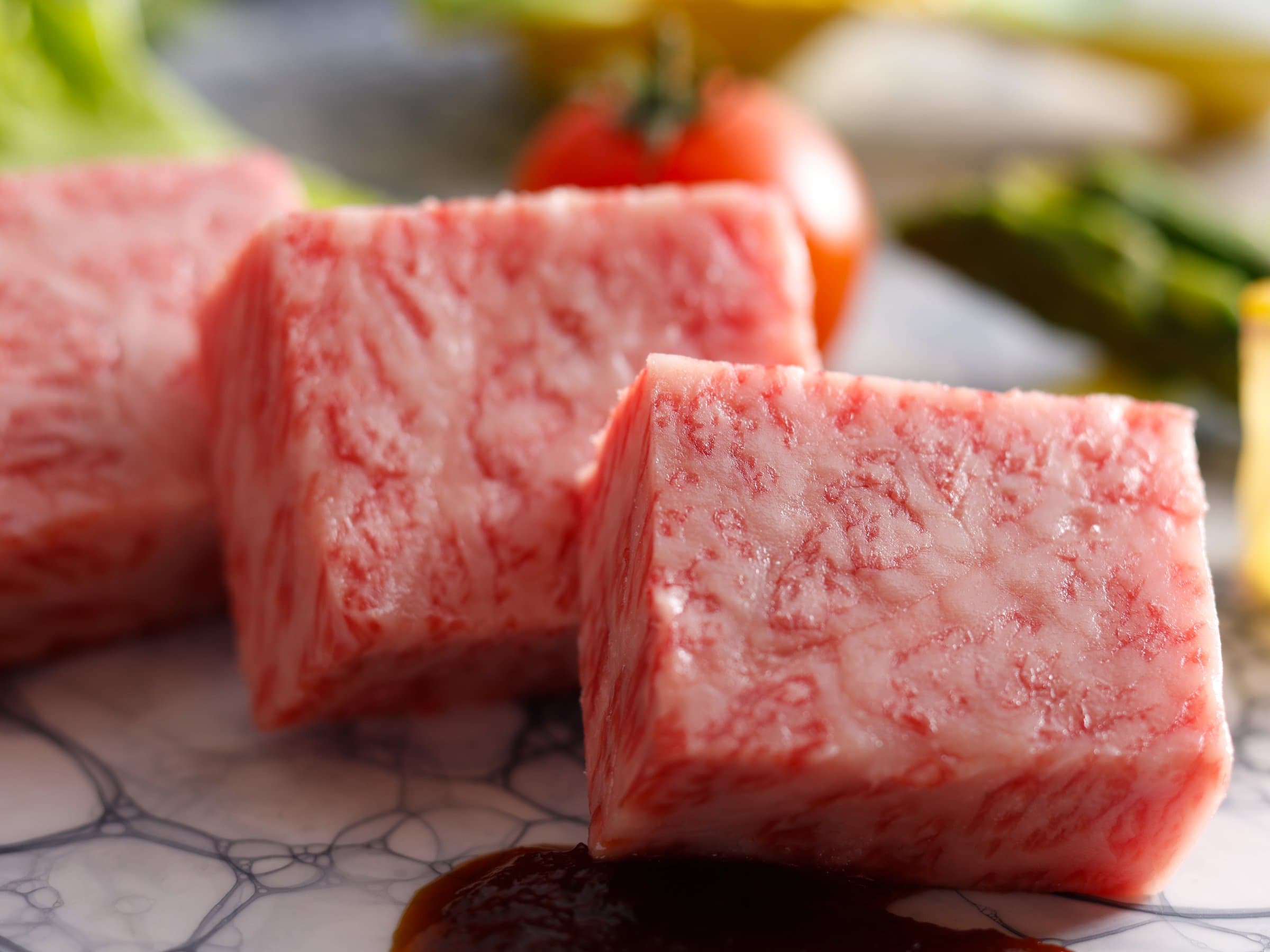 Close-up of richly marbled local wagyu beef cubes plated for the kaiseki dinner at Dogo Onsen Hanayuzuki