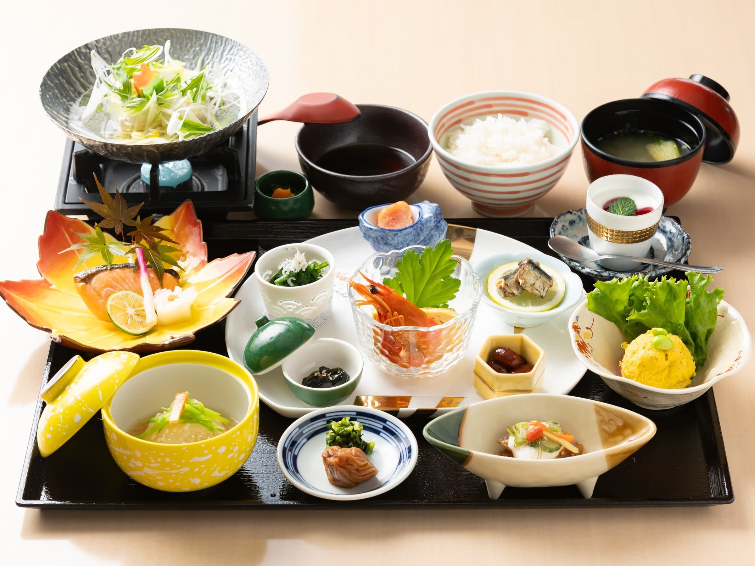 Traditional Japanese breakfast set with assorted small dishes, rice and accompaniments, Ryokan Chobonoyado Shiori, Beppu Onsen