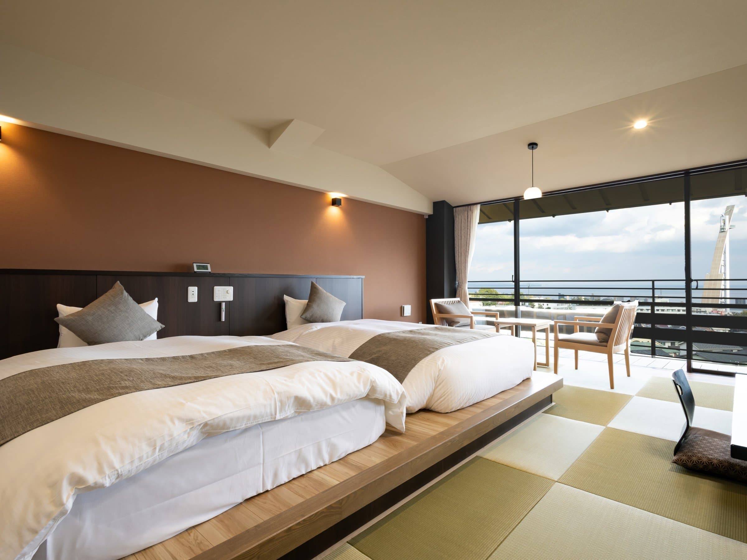 Nine-tatami Japanese-Western sea-side guest room with bedding and bay-facing windows, Ryokan Chobonoyado Shiori, Beppu Onsen