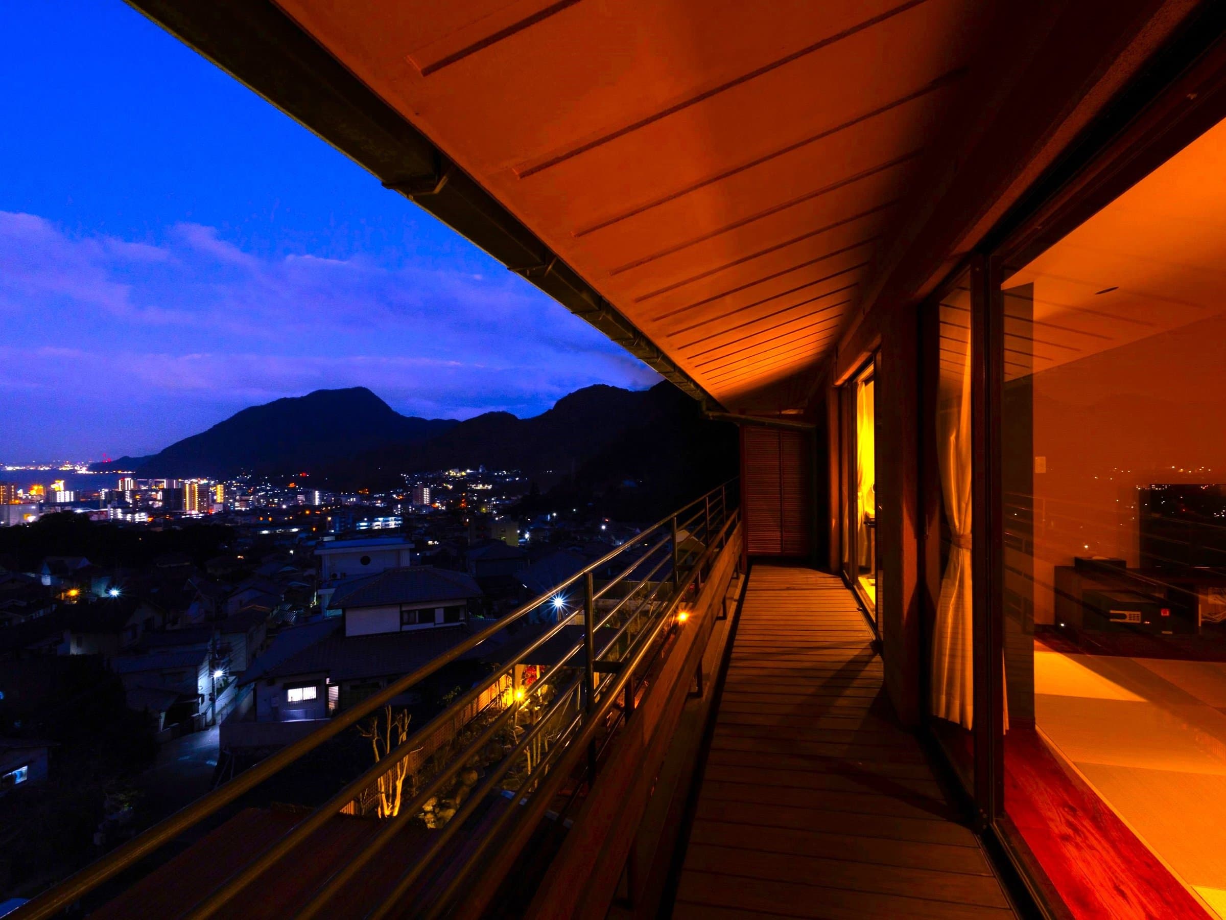 Sea-side third-floor guest room overlooking Beppu Bay and the surrounding townscape, Ryokan Chobonoyado Shiori, Beppu Onsen