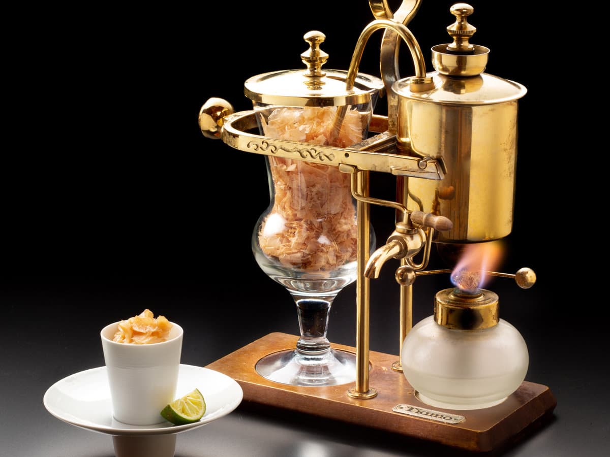 Tableside dish with a brass siphon and bonito flakes served at Kissho Caren in Izu Inatori