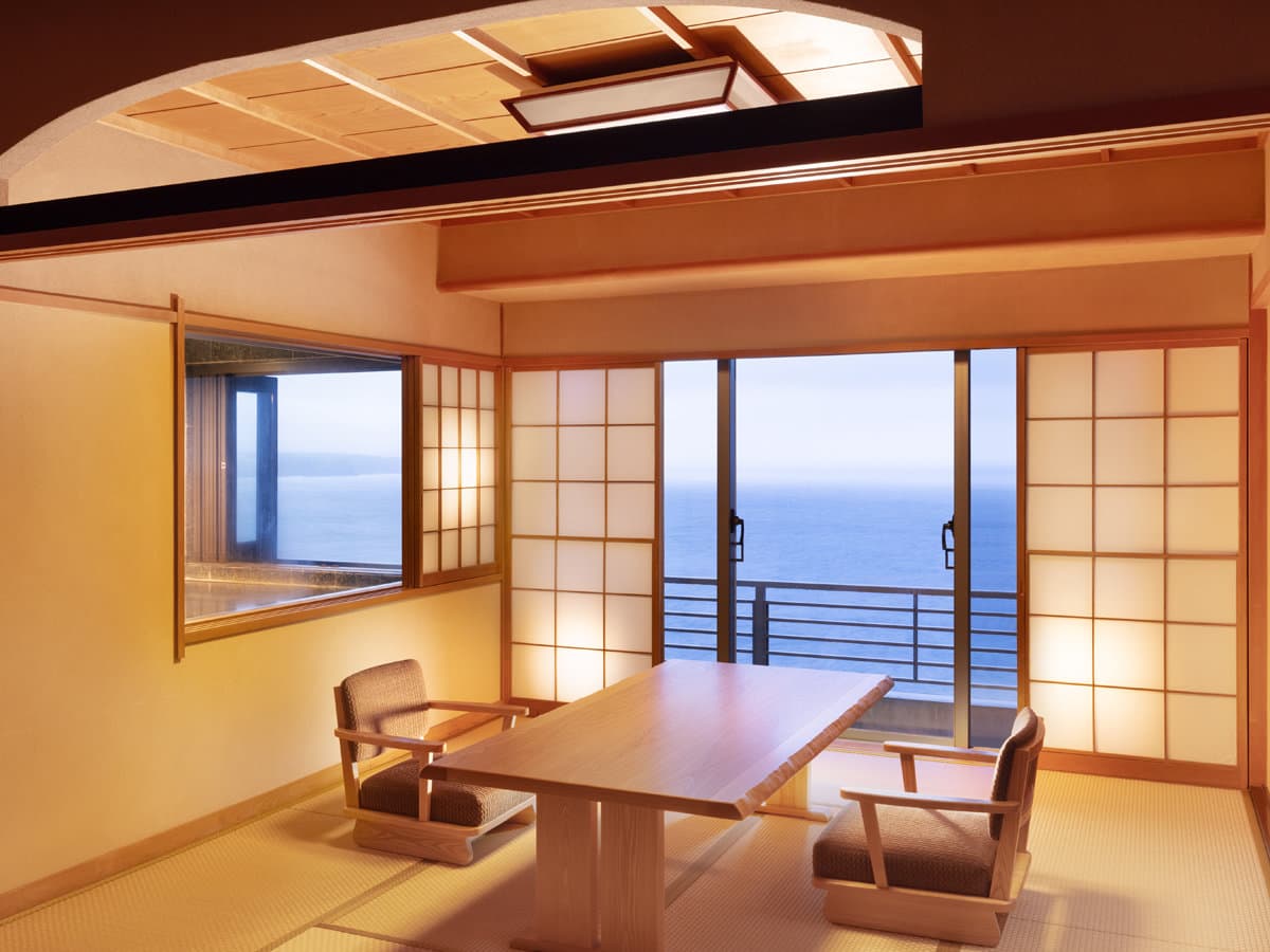 Tatami guest room with shoji screens and a wide ocean view at Kissho Caren in Izu