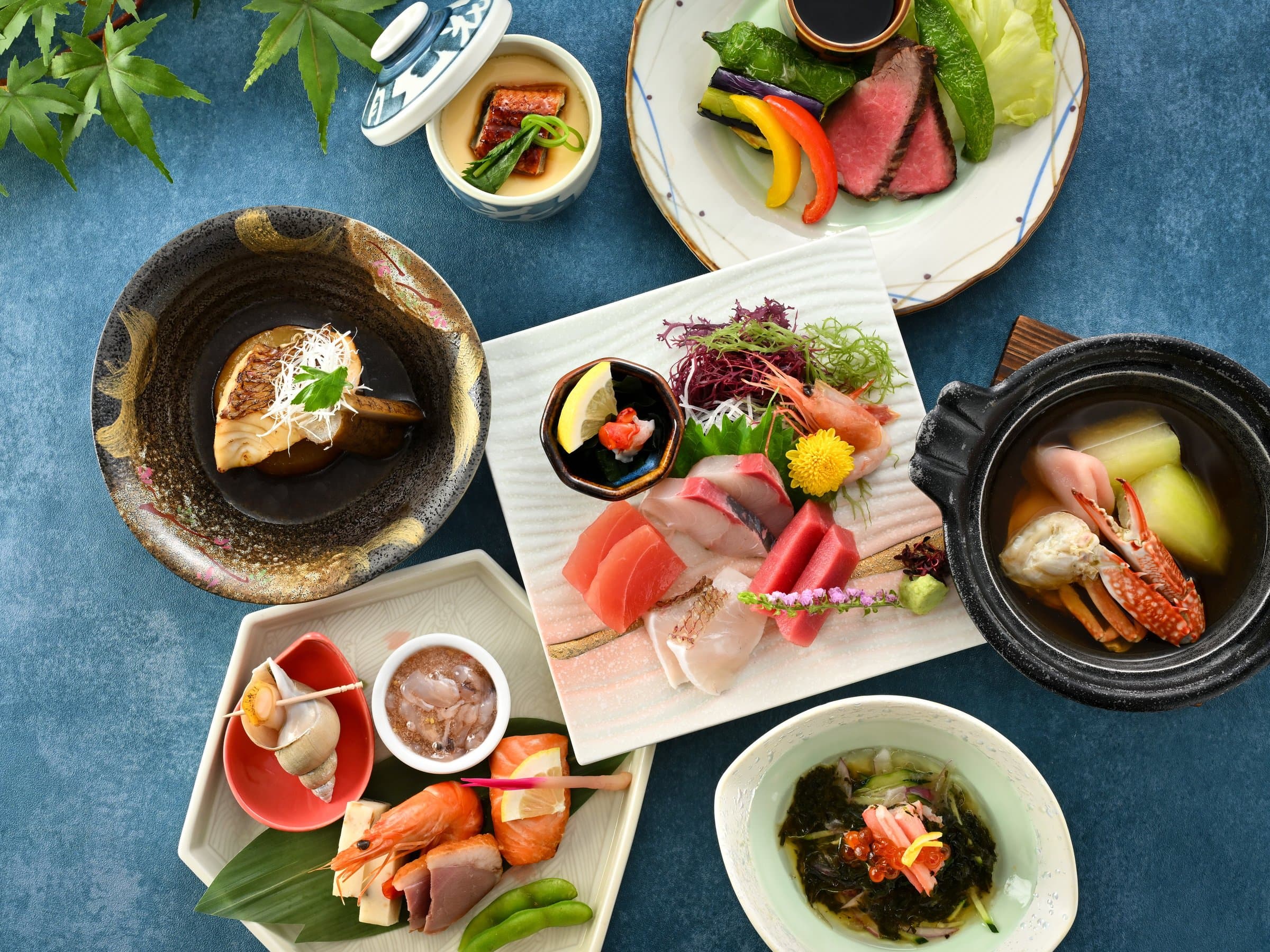 Multi-course kaiseki spread with sashimi, grilled wagyu and simmered fish at Hamazuru, Wakura Onsen