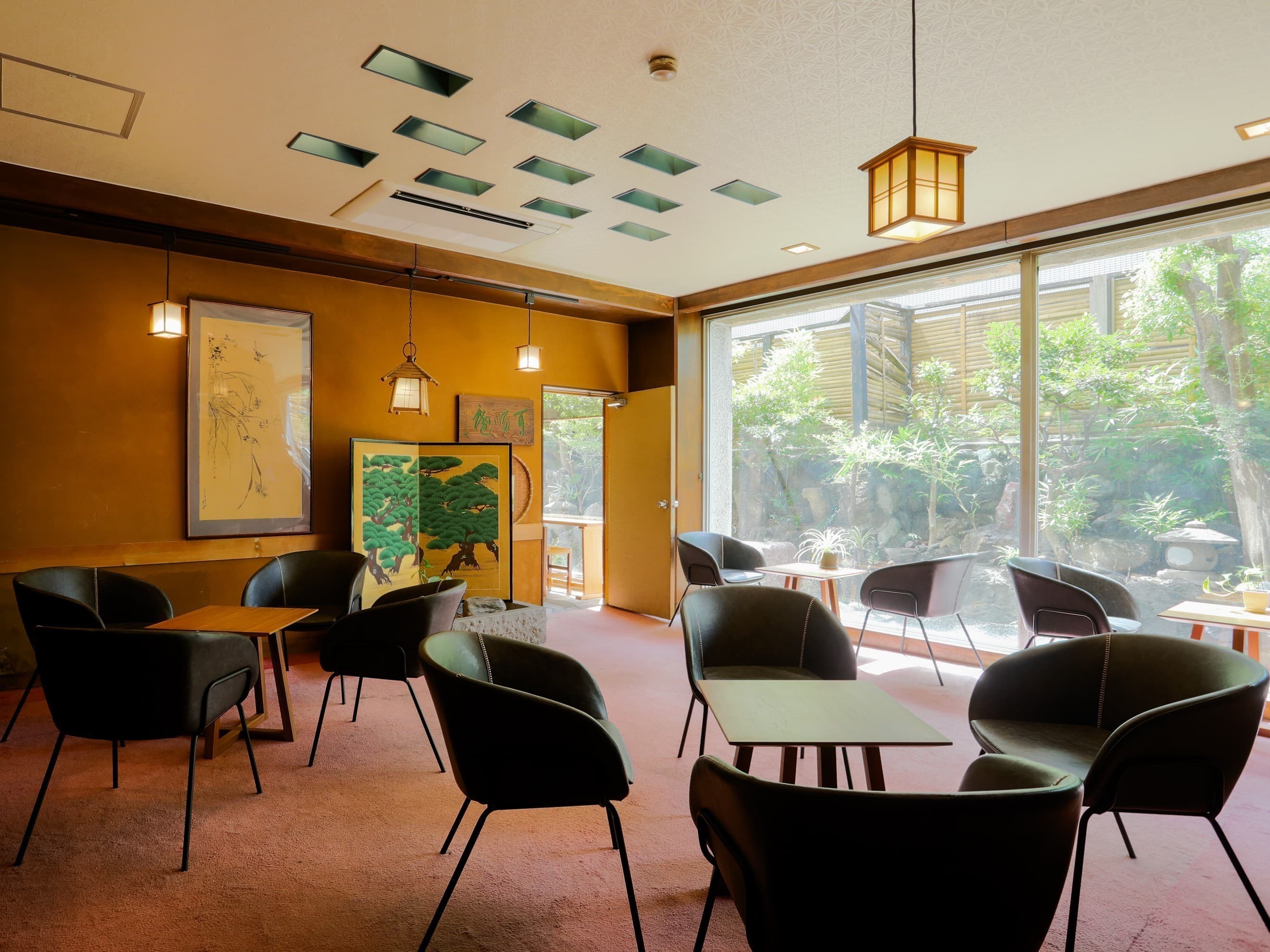 Lobby lounge with armchairs and floor-to-ceiling windows overlooking a stone garden at Hotel Edoya, Tokyo