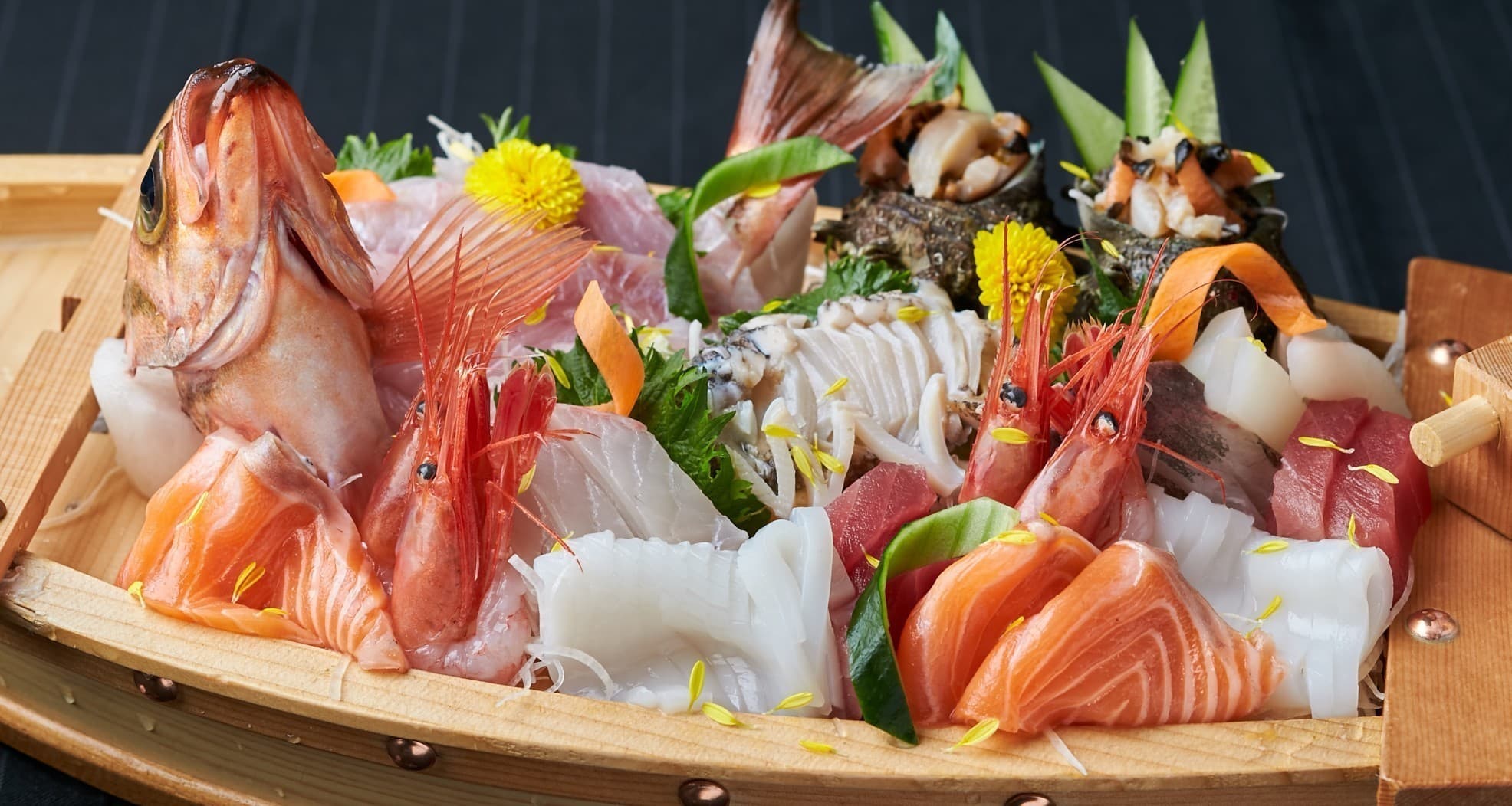 Lavish boat-shaped platter of fresh sashimi and turban shells at Matsuya