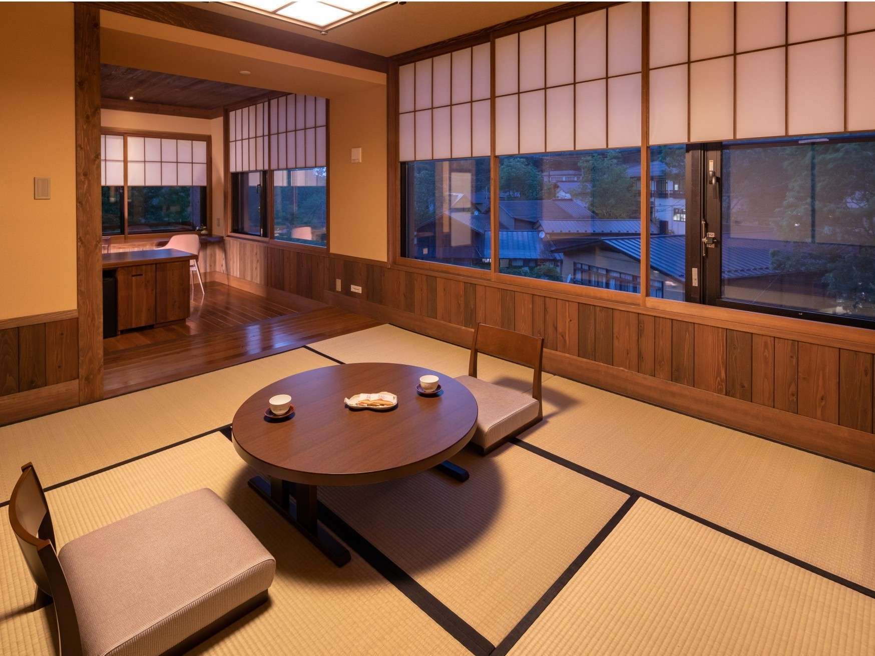 Tatami guest room with low table and futon at Ryokan Nanjoen