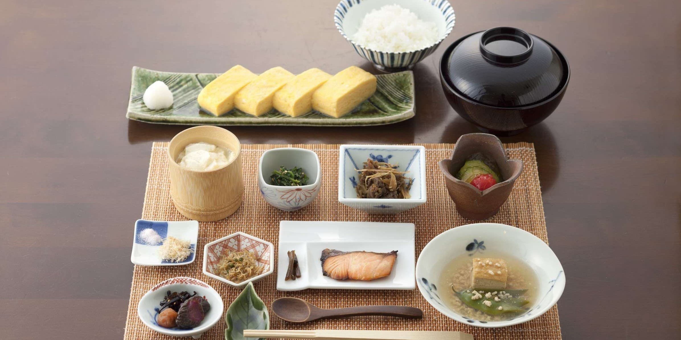 Kaiseki dinner spread at Kusatsu Hotel Annex Wata-no-Yu with sashimi, hot pot, wagyu and assorted small dishes on a black lacquer tray