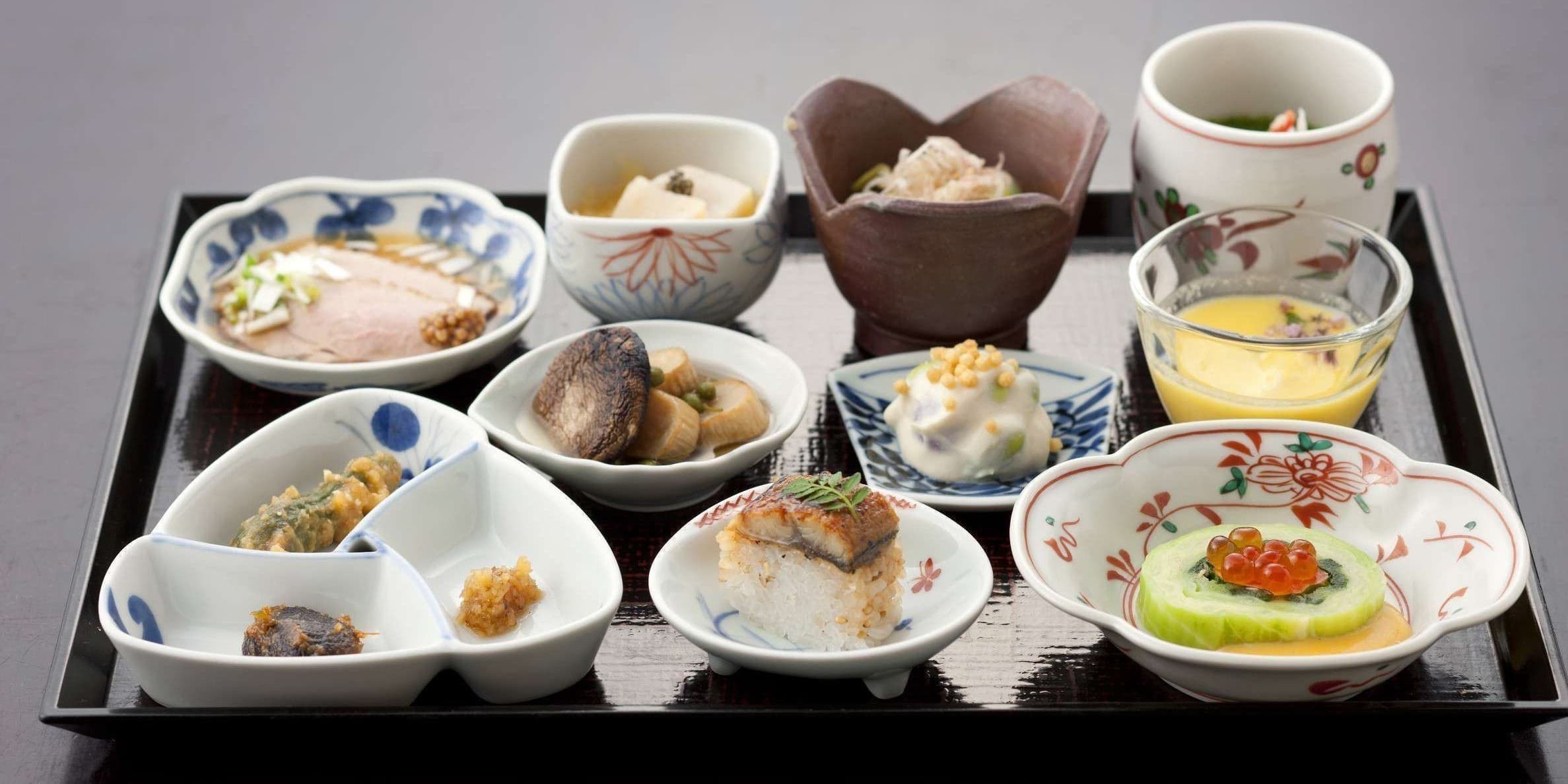 Assorted small Japanese dishes on a black lacquer tray served at Wata-no-Yu